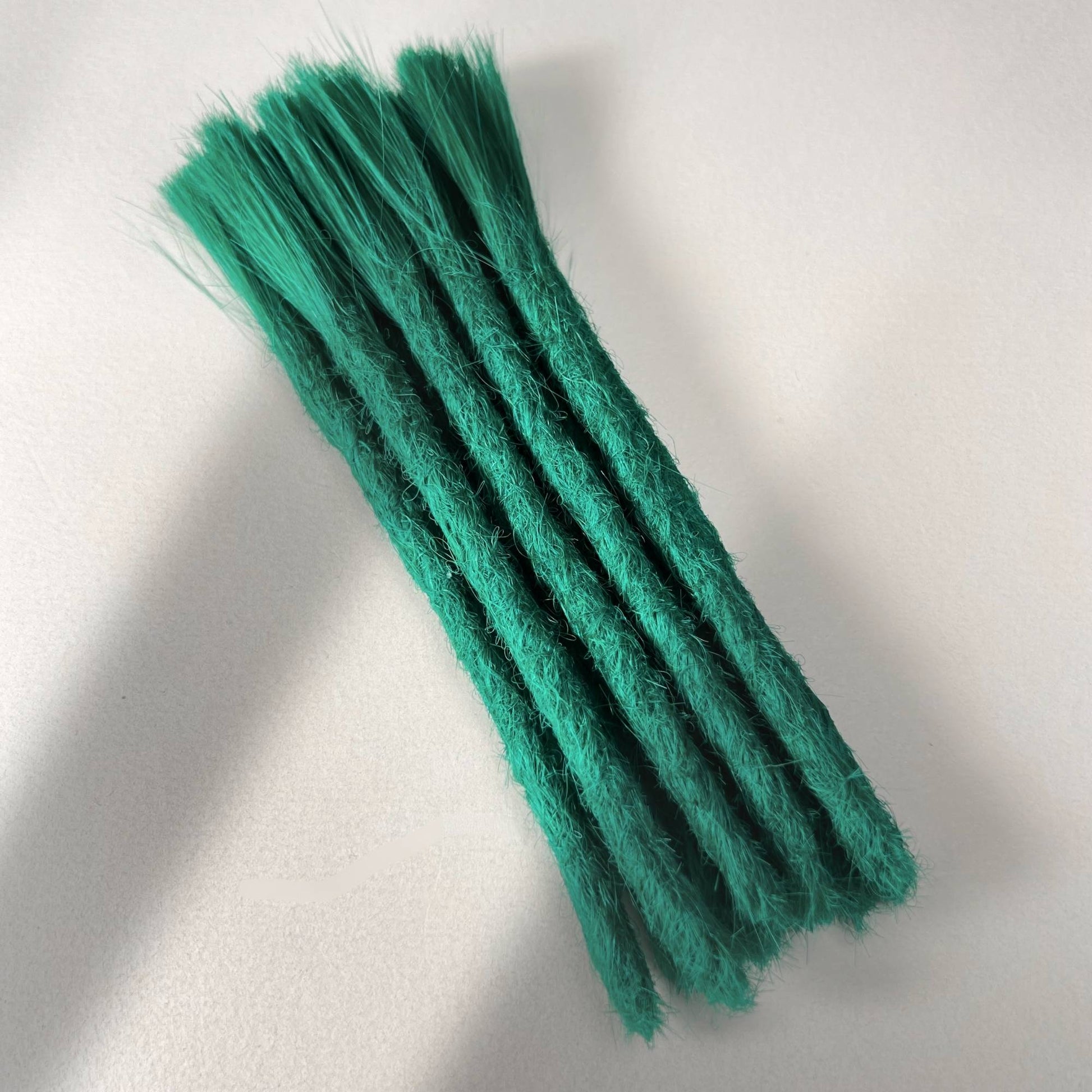 Full view of permanent straight loc extensions with blunt ends in Emerald Green.