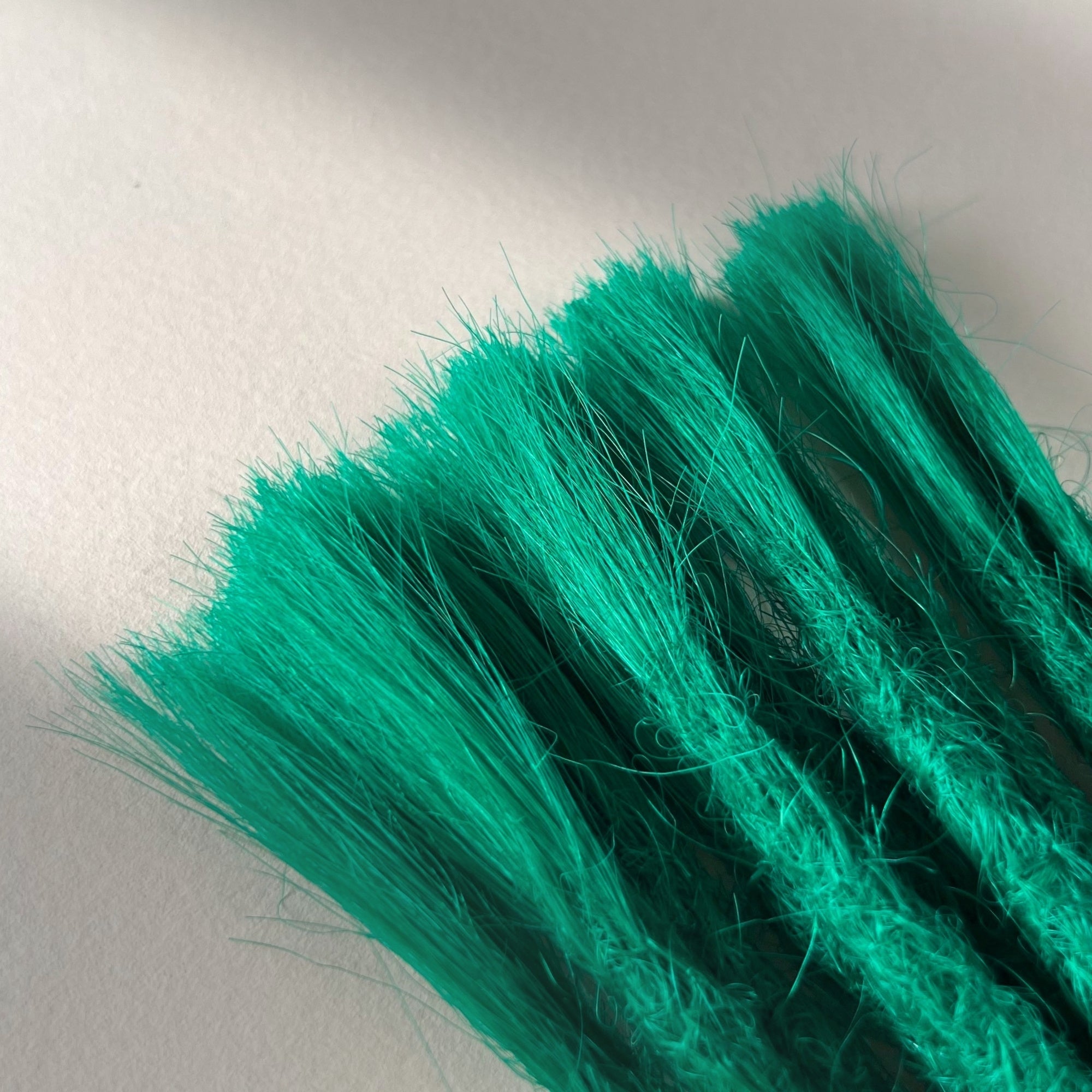 Connection point of permanent straight loc extensions in Emerald Green.