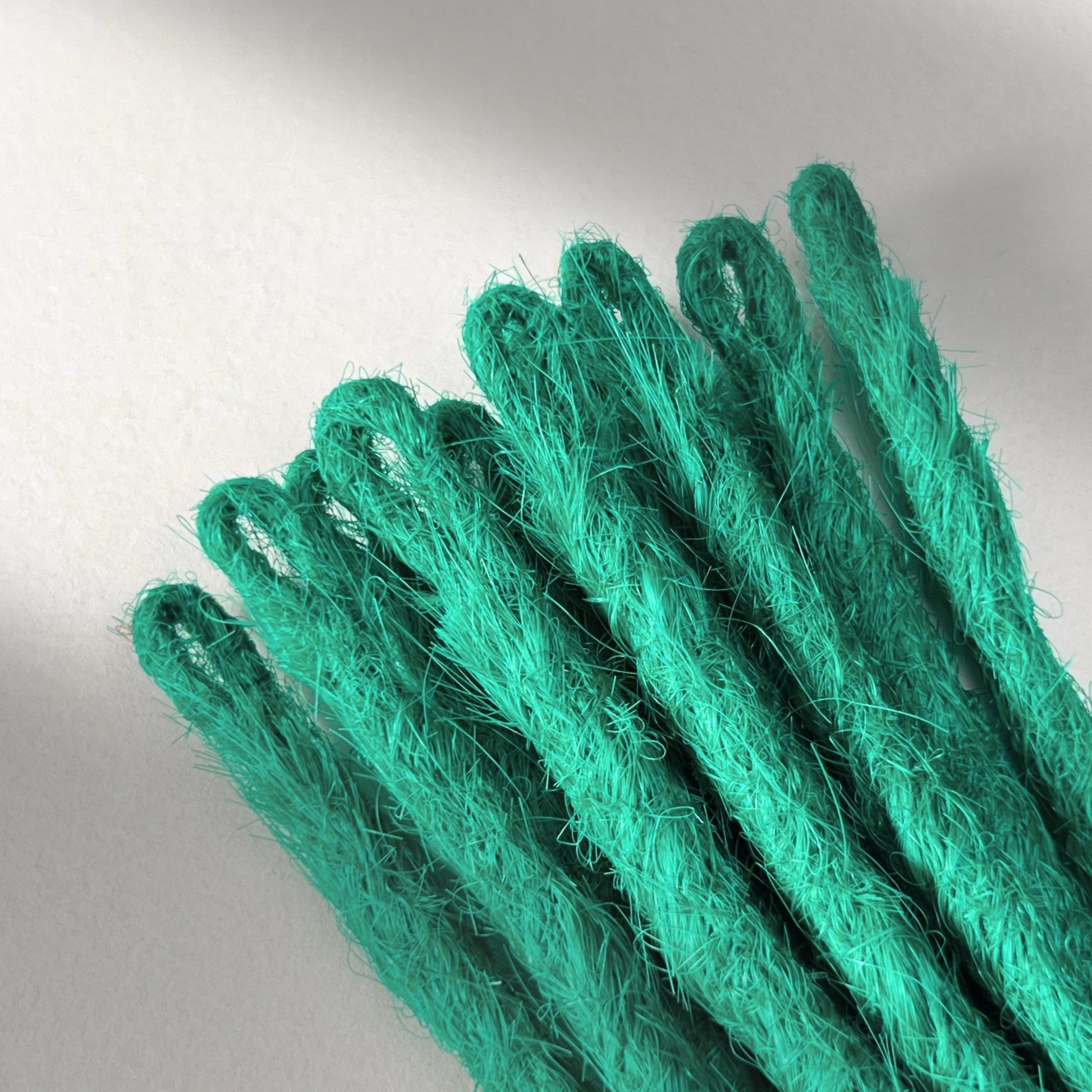 Loop detail of temporary single-ended straight loc extensions in Emerald Green.