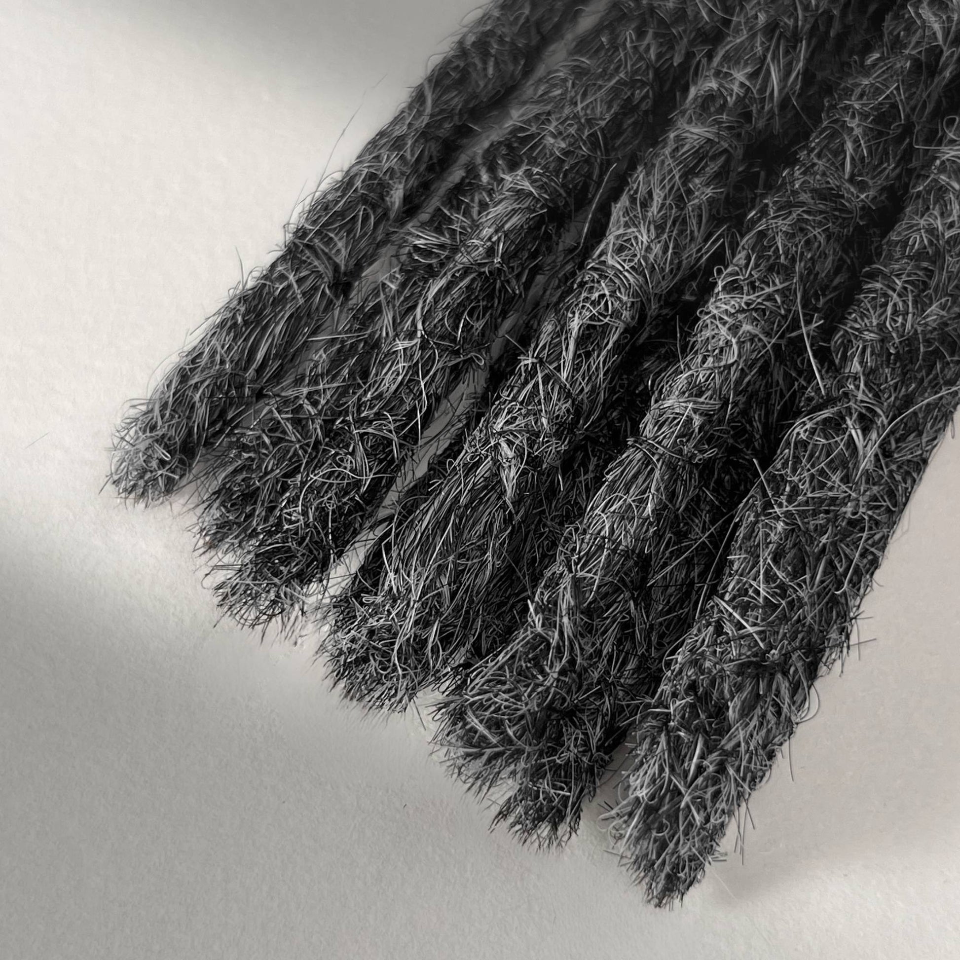 Tip detail of straight loc extensions with blunt ends in Steel Silver.
