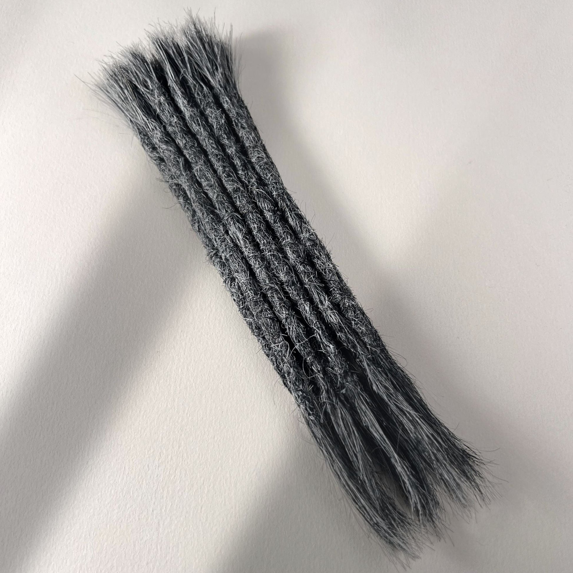Full view of permanent straight loc extensions with open ends in Steel Silver.