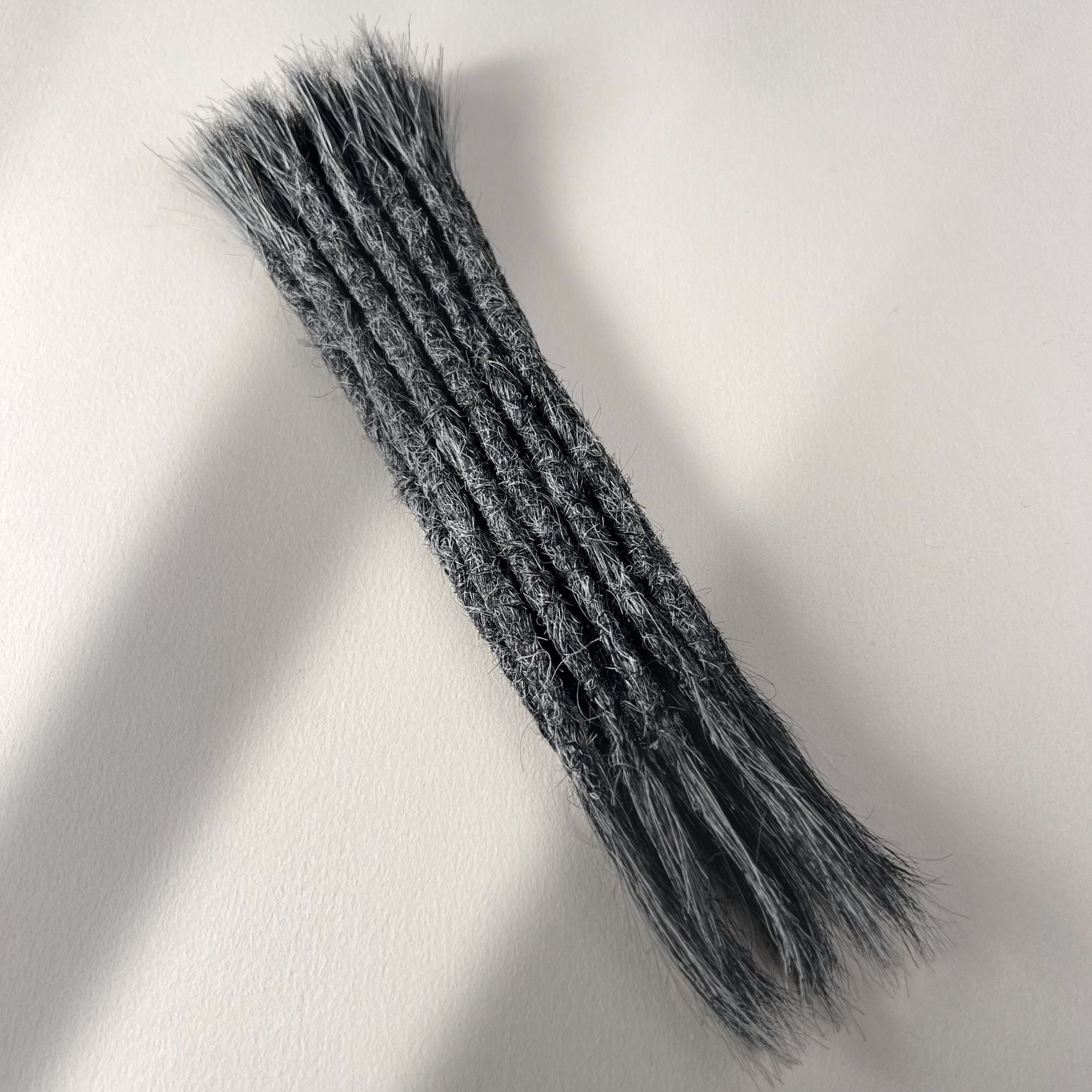 Full view of permanent straight loc extensions with open ends in Steel Silver.