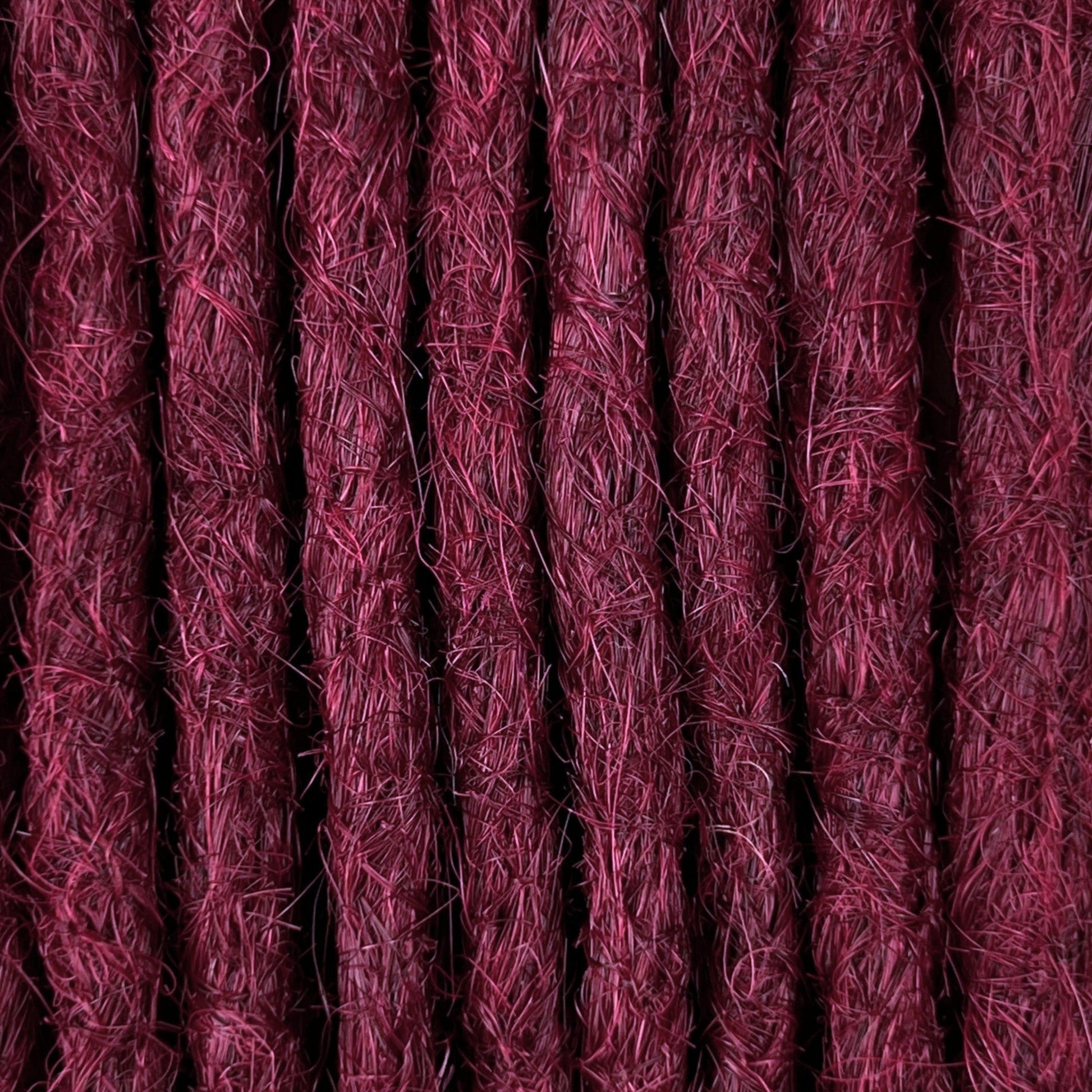 Close-up of straight loc extensions in Dark Cherry Red, showing the texture and color.