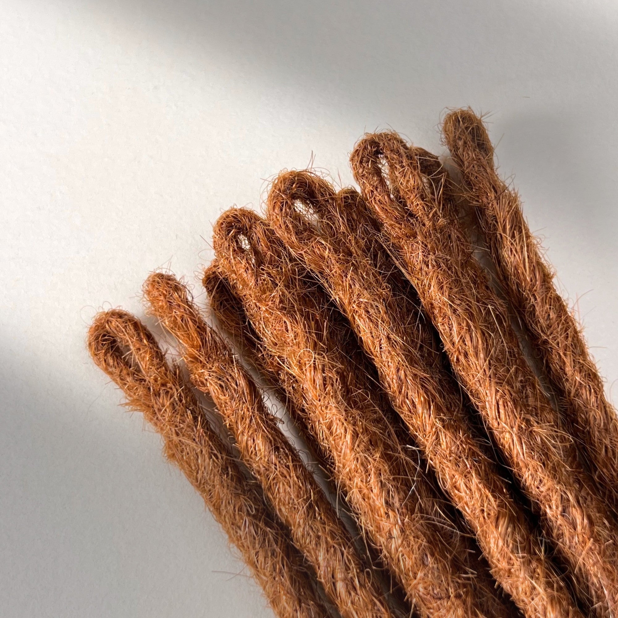 Loop detail of temporary single-ended straight loc extensions in Burnt Copper.