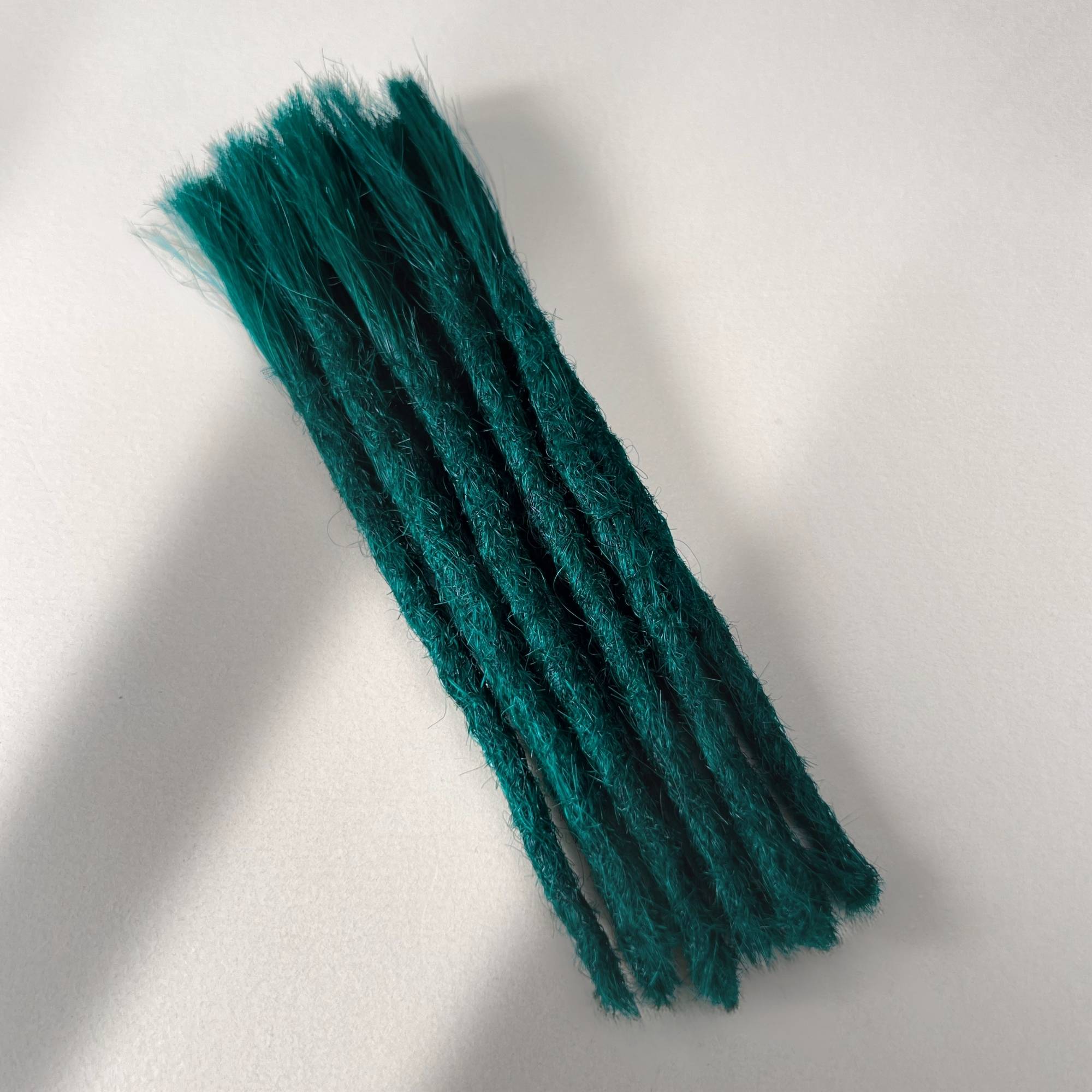 Full view of permanent straight loc extensions with blunt ends in Forest Green.