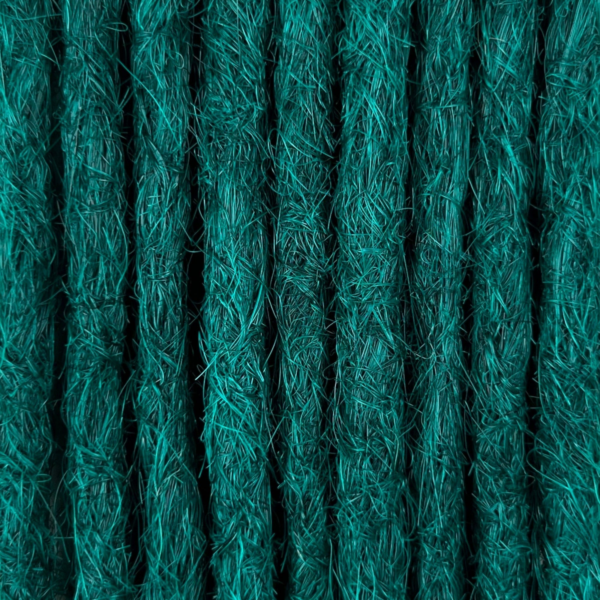 Close-up of straight loc extensions in Forest Green, showing the texture and color.