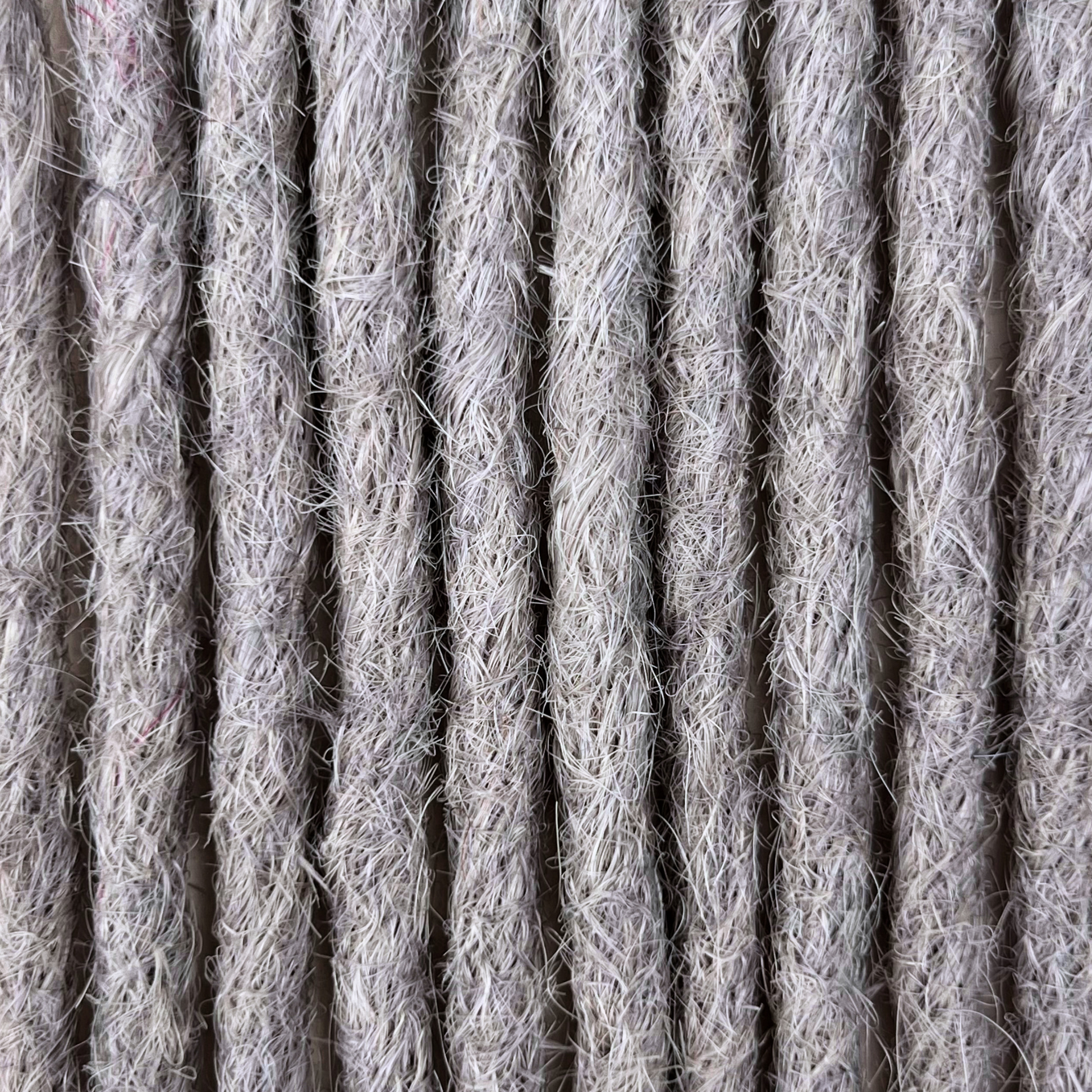 Close-up of straight loc extensions in Pearl Silver, showing the texture and color.