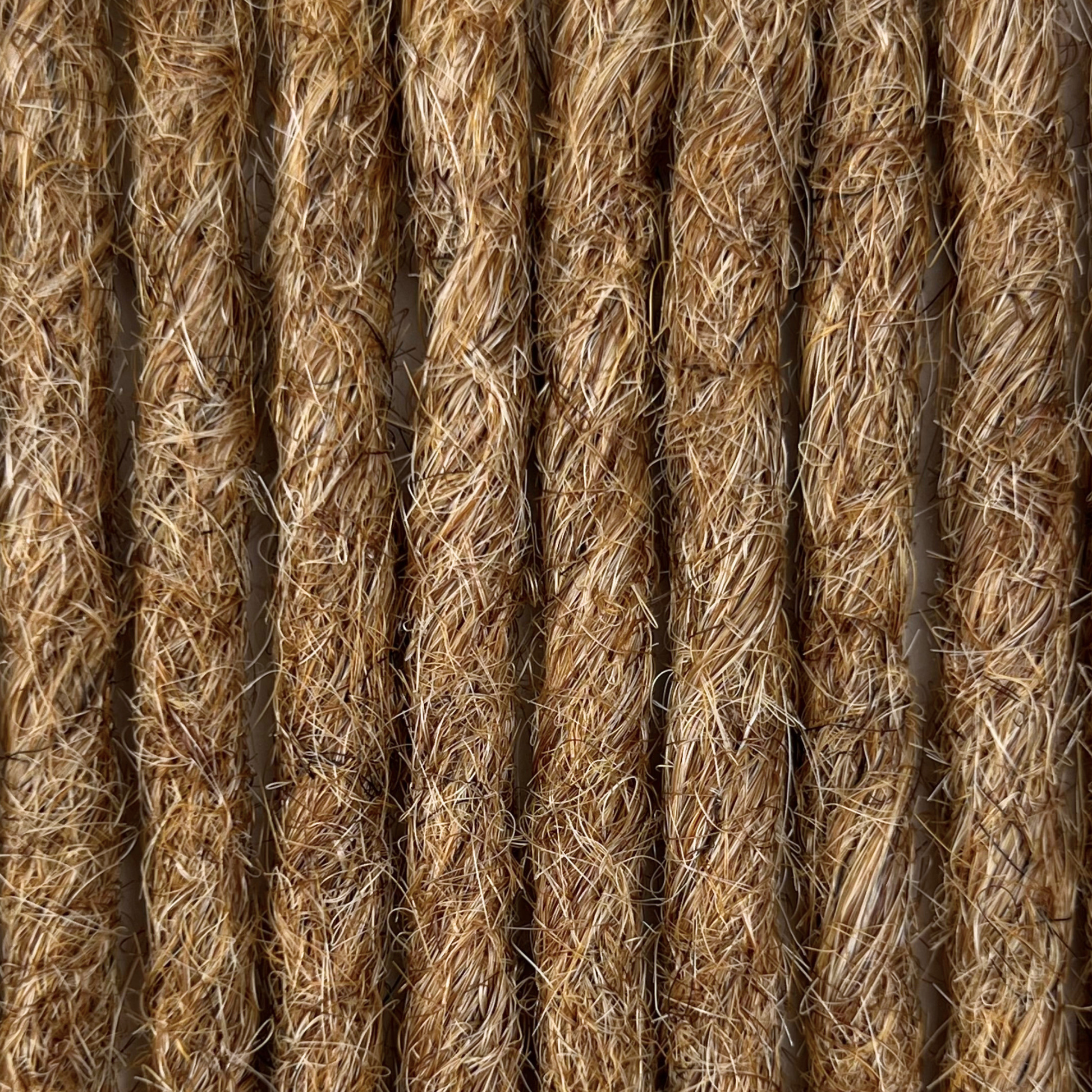 Close-up of straight loc extensions in Honey Blonde, showing the texture and color.