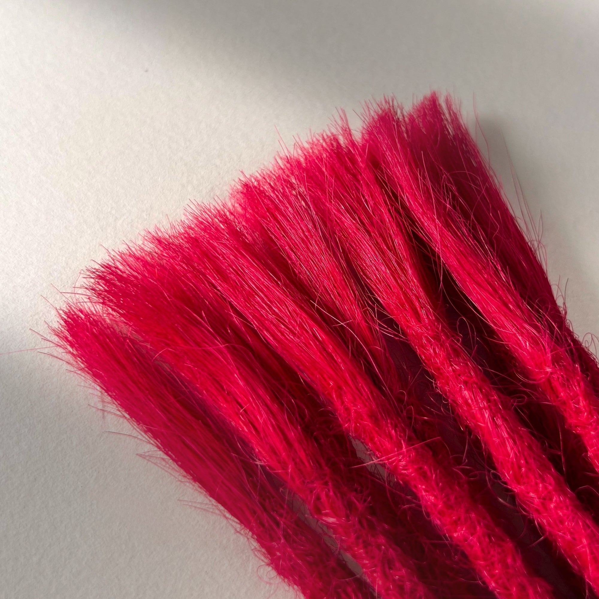 Connection point of permanent straight loc extensions in Indian Pink.