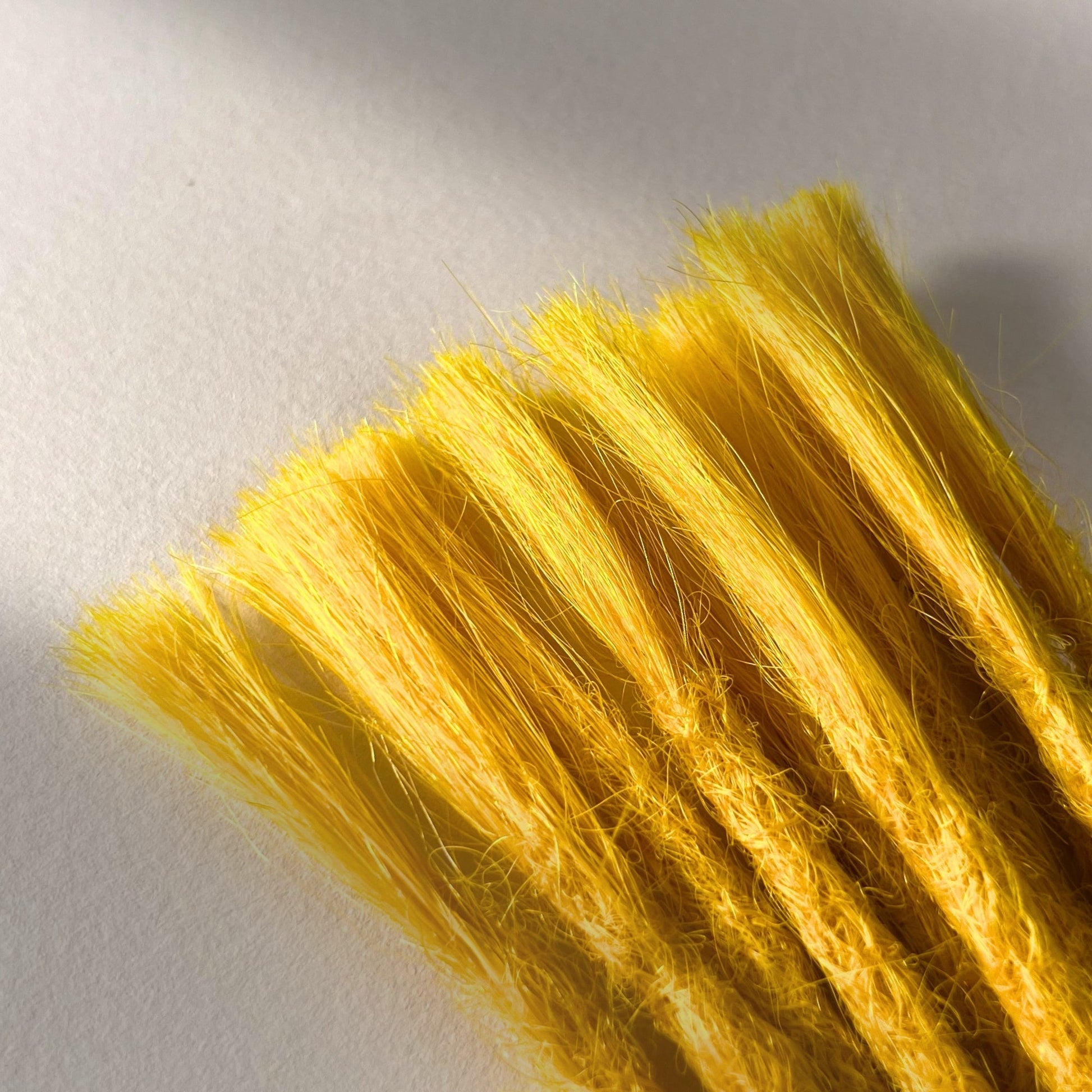 Connection point of permanent straight loc extensions in Lemon Yellow.