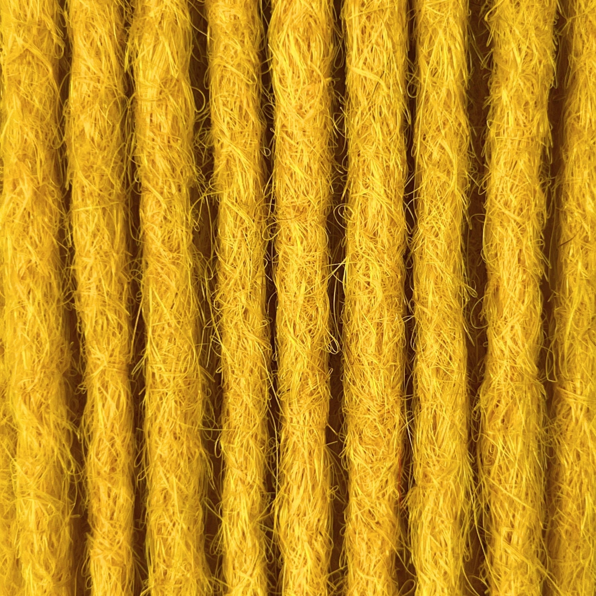 Close-up of straight loc extensions in Lemon Yellow, showing the texture and color.