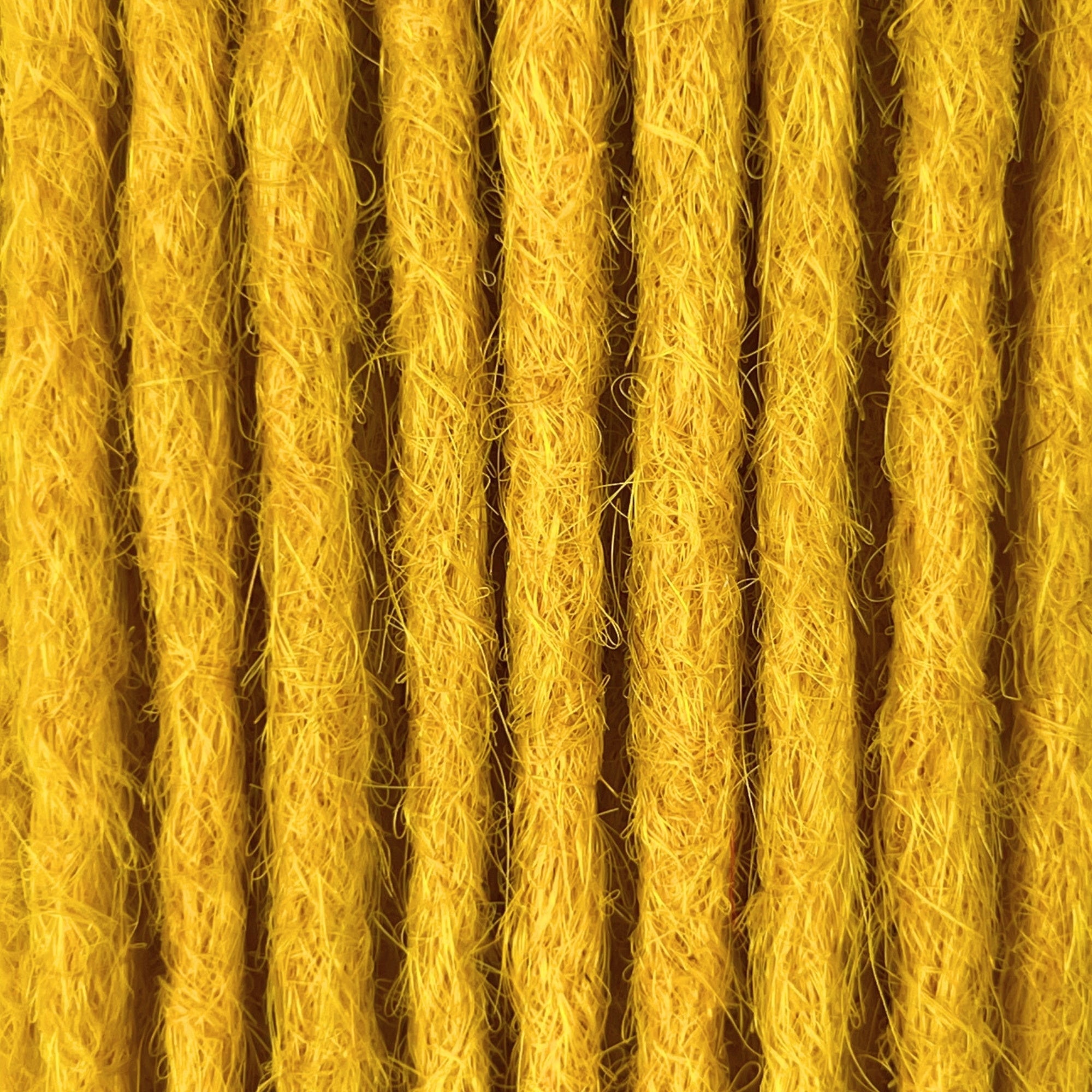 Close-up of straight loc extensions in Lemon Yellow, showing the texture and color.