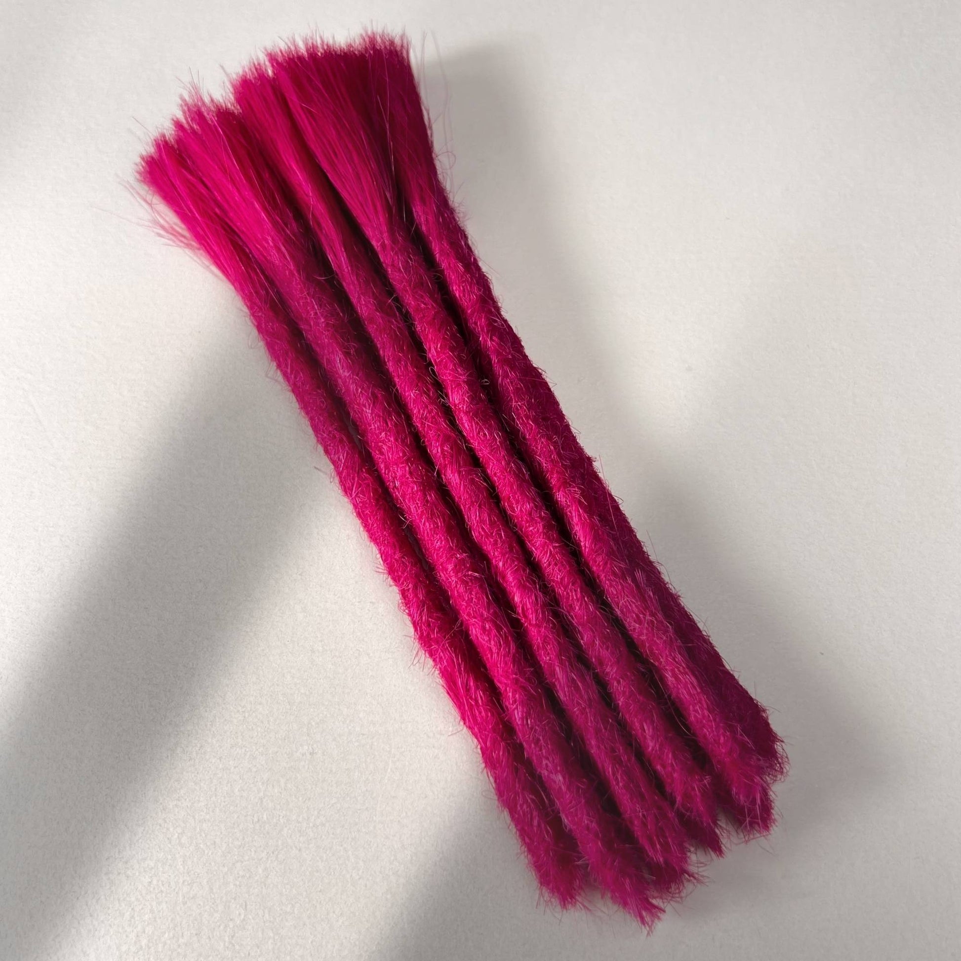 Full view of permanent straight loc extensions with blunt ends in Magenta Pink.