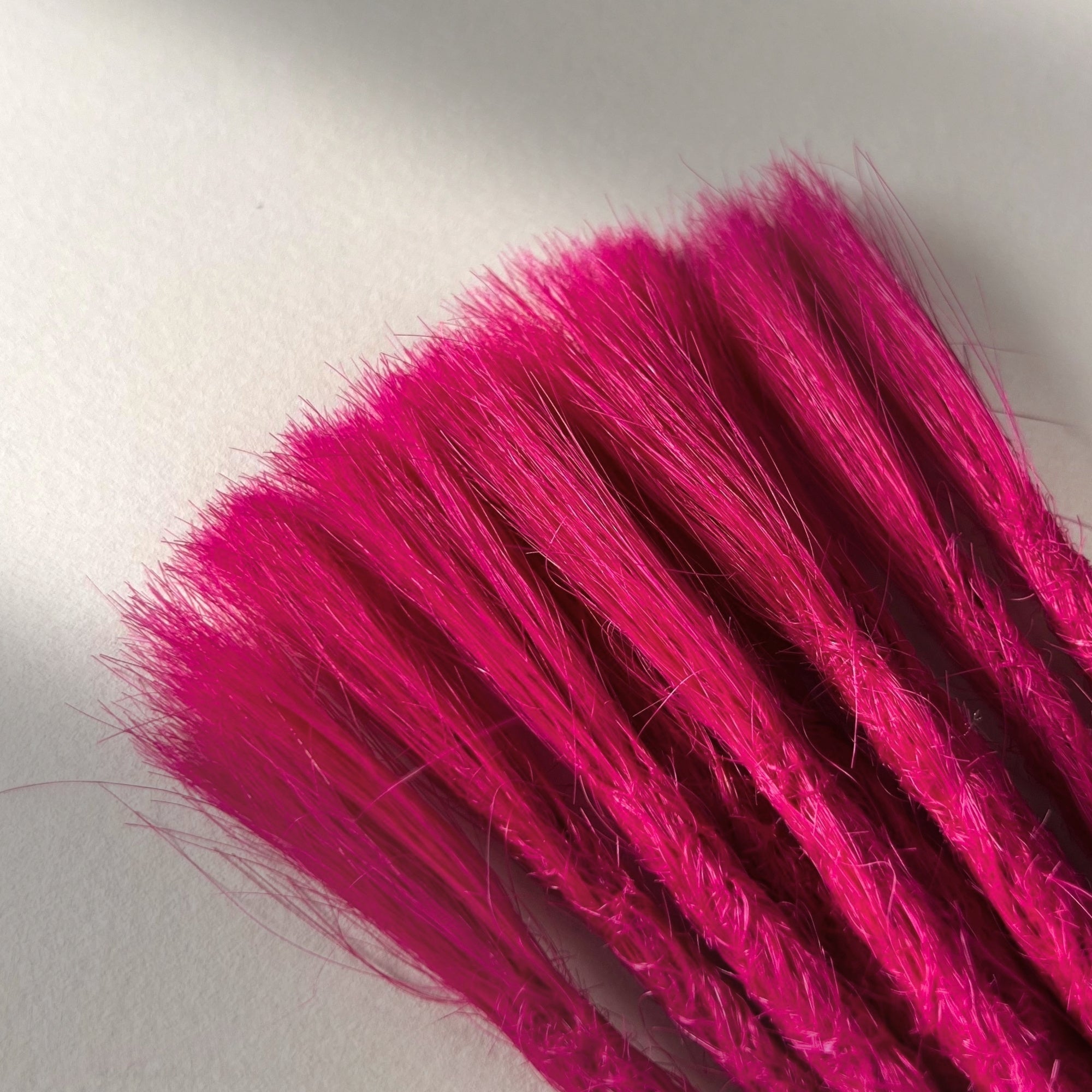 Connection point of permanent straight loc extensions in Magenta Pink.