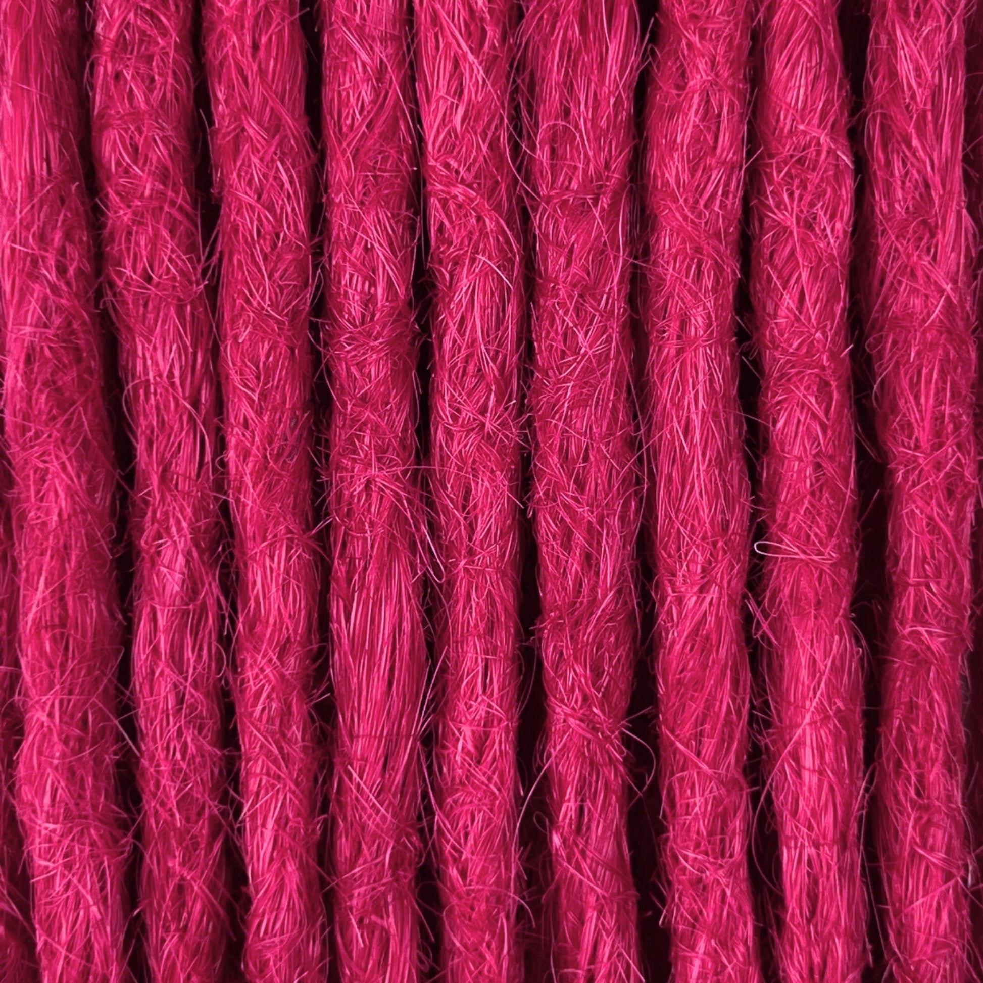 Close-up of straight loc extensions in Magenta Pink, showing the texture and color.