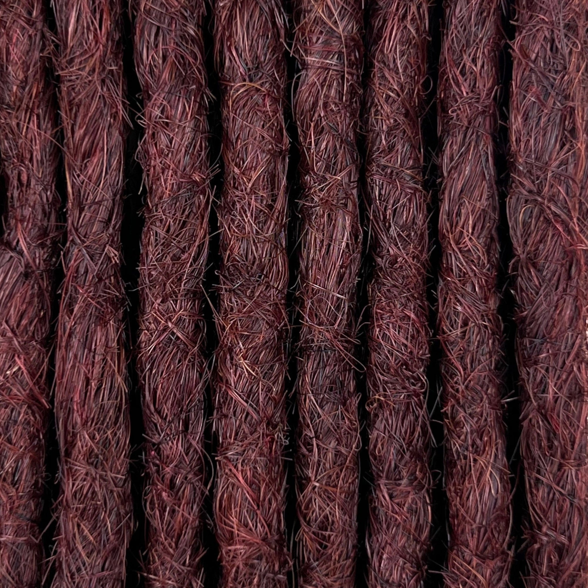 Close-up of straight loc extensions in Warm Mahogany Red, showing the texture and color.