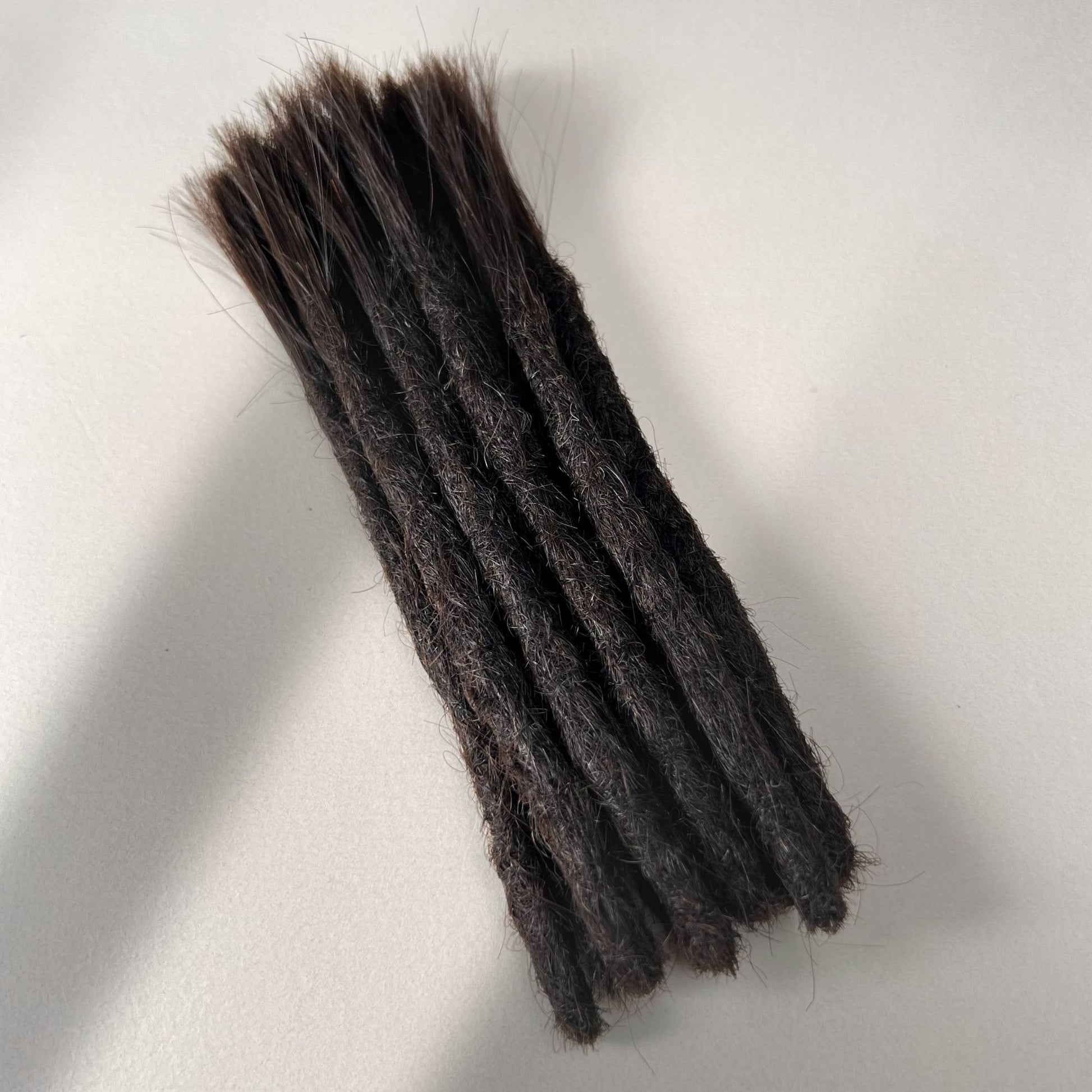 Handcrafted Straight Human Hair Loc Extensions in Morion with Blunt Ends for permanent installation shown in full view.