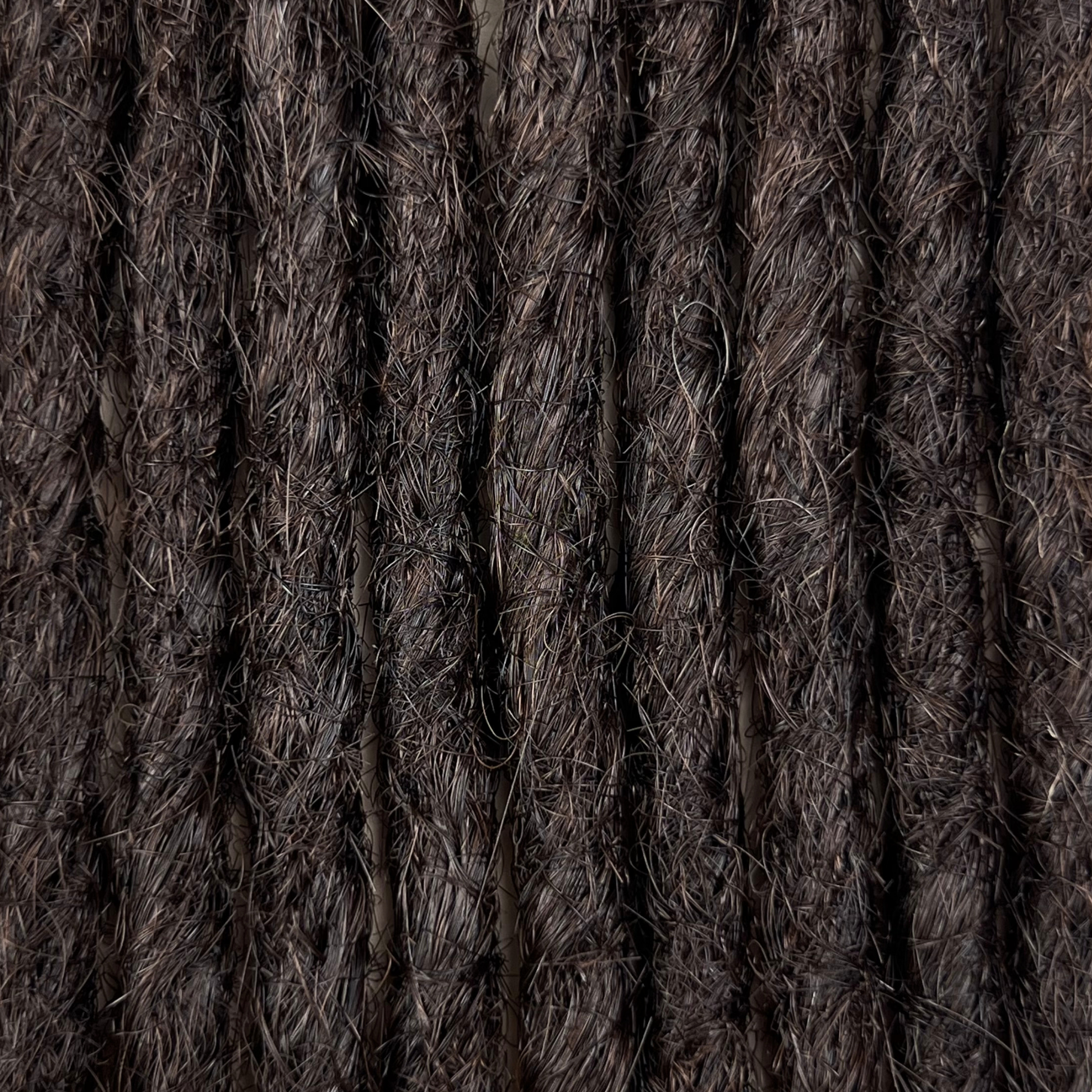 Close-up of straight loc extensions in Deep Brown, showing the texture and color.