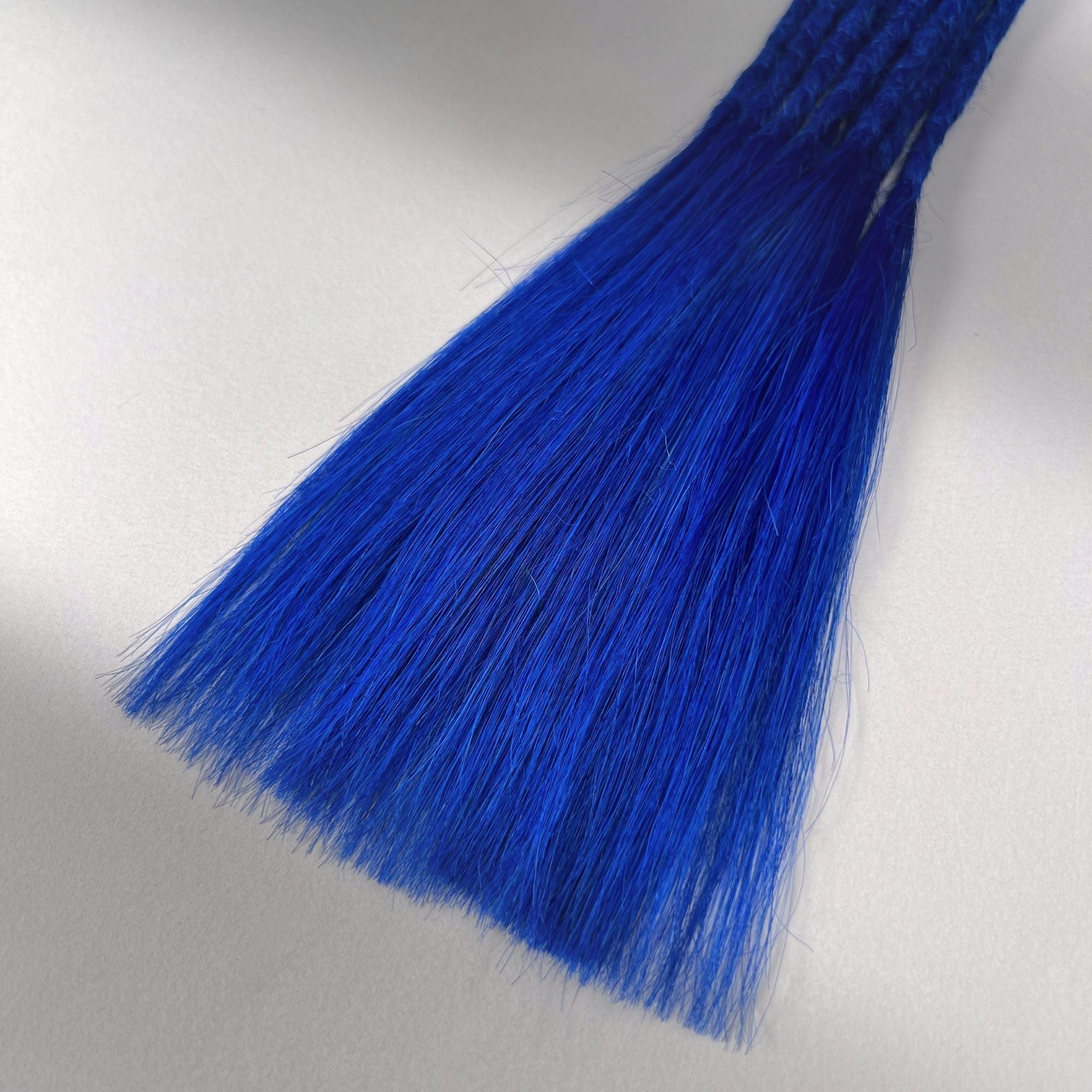 Tip detail of straight loc extensions with long loose ends in Deep Navy Blue.