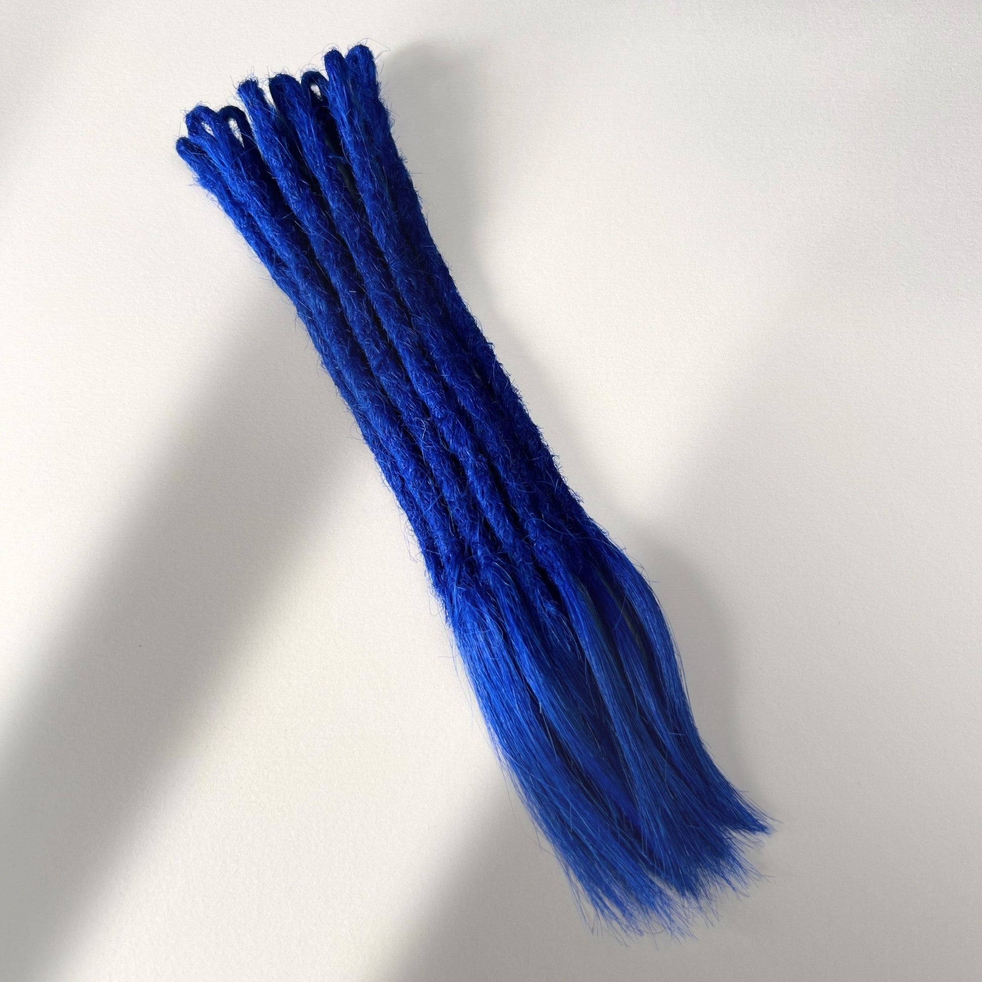 Full view of temporary single-ended straight loc extensions with open ends in Deep Navy Blue.