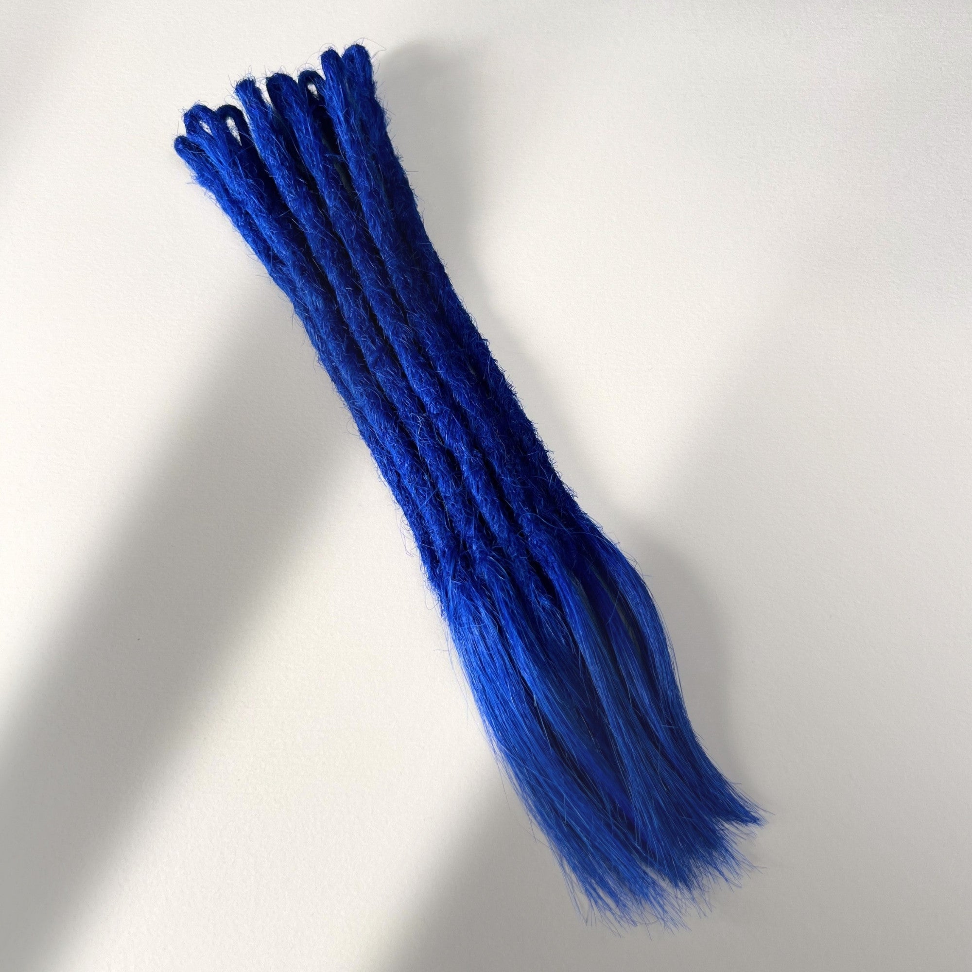 Full view of temporary single-ended straight loc extensions with open ends in Deep Navy Blue.