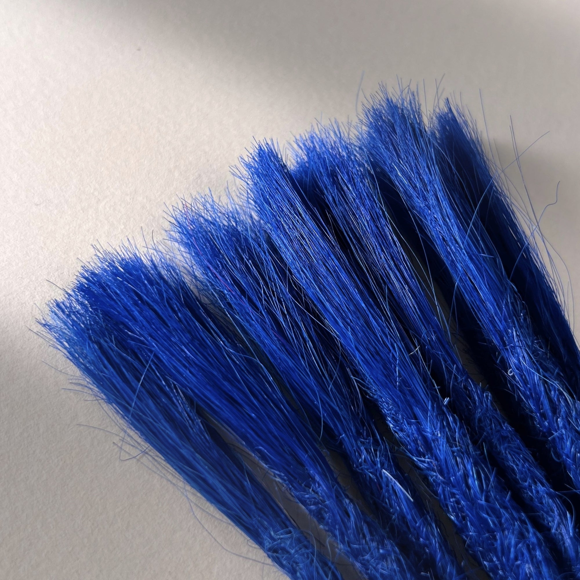 Connection point of permanent straight loc extensions in Deep Navy Blue.