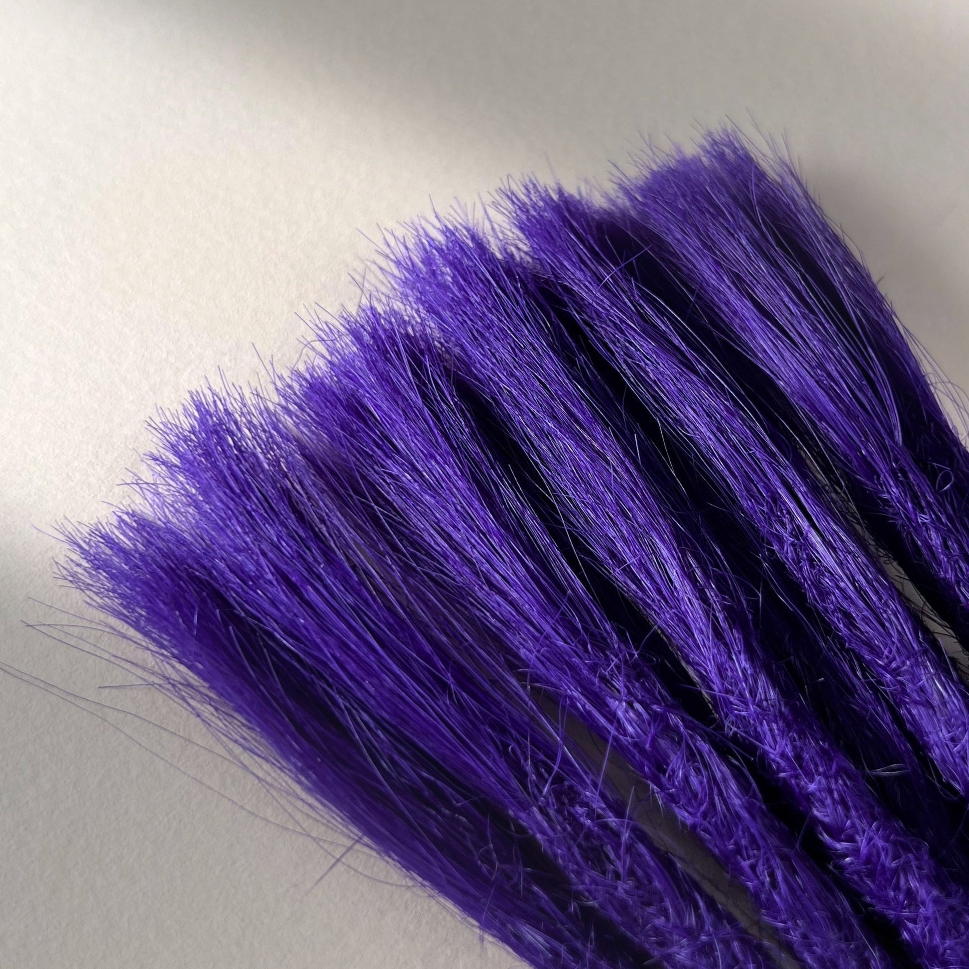 Connection point of permanent straight loc extensions in Orchid Violet.