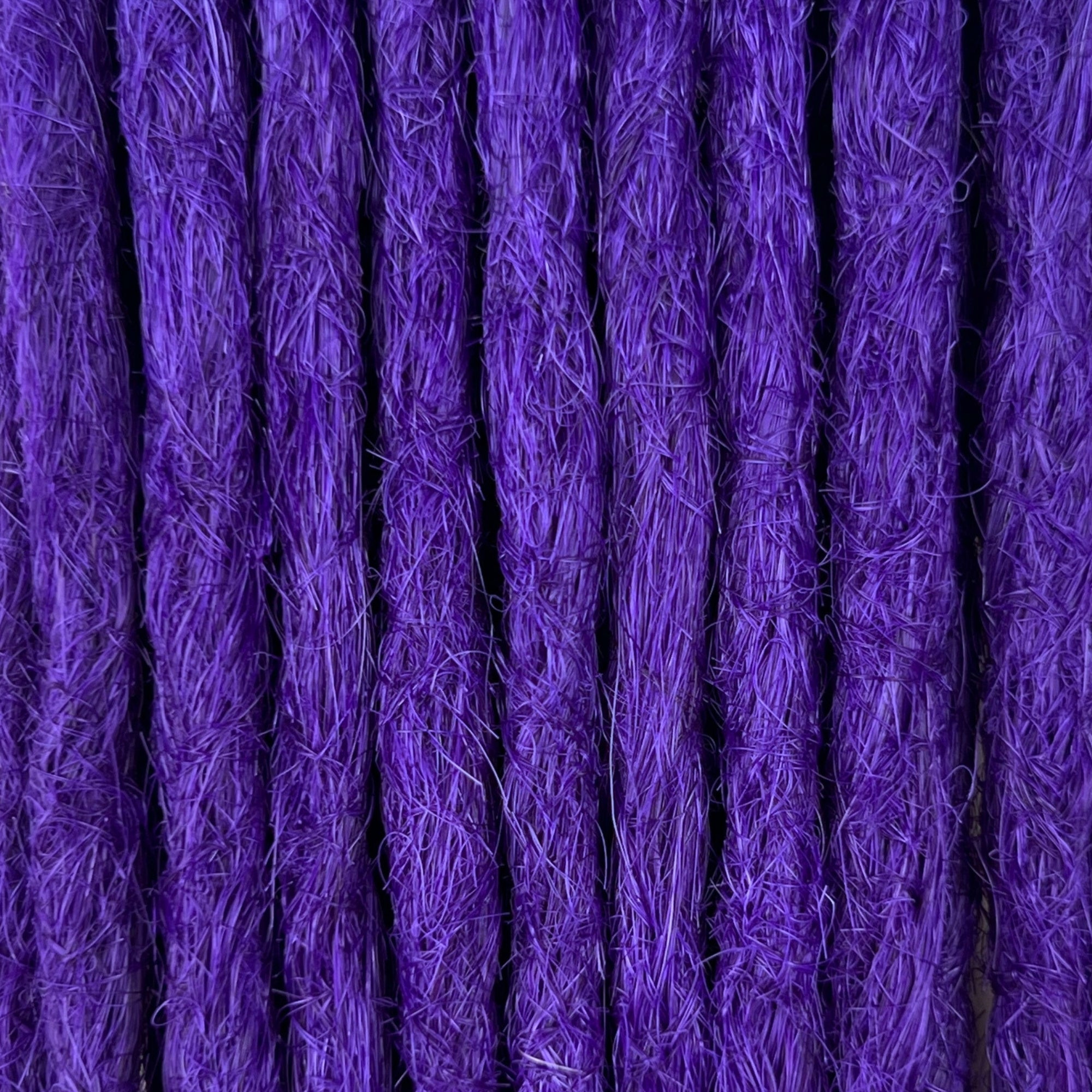 Close-up of straight loc extensions in Orchid Violet, showing the texture and color.
