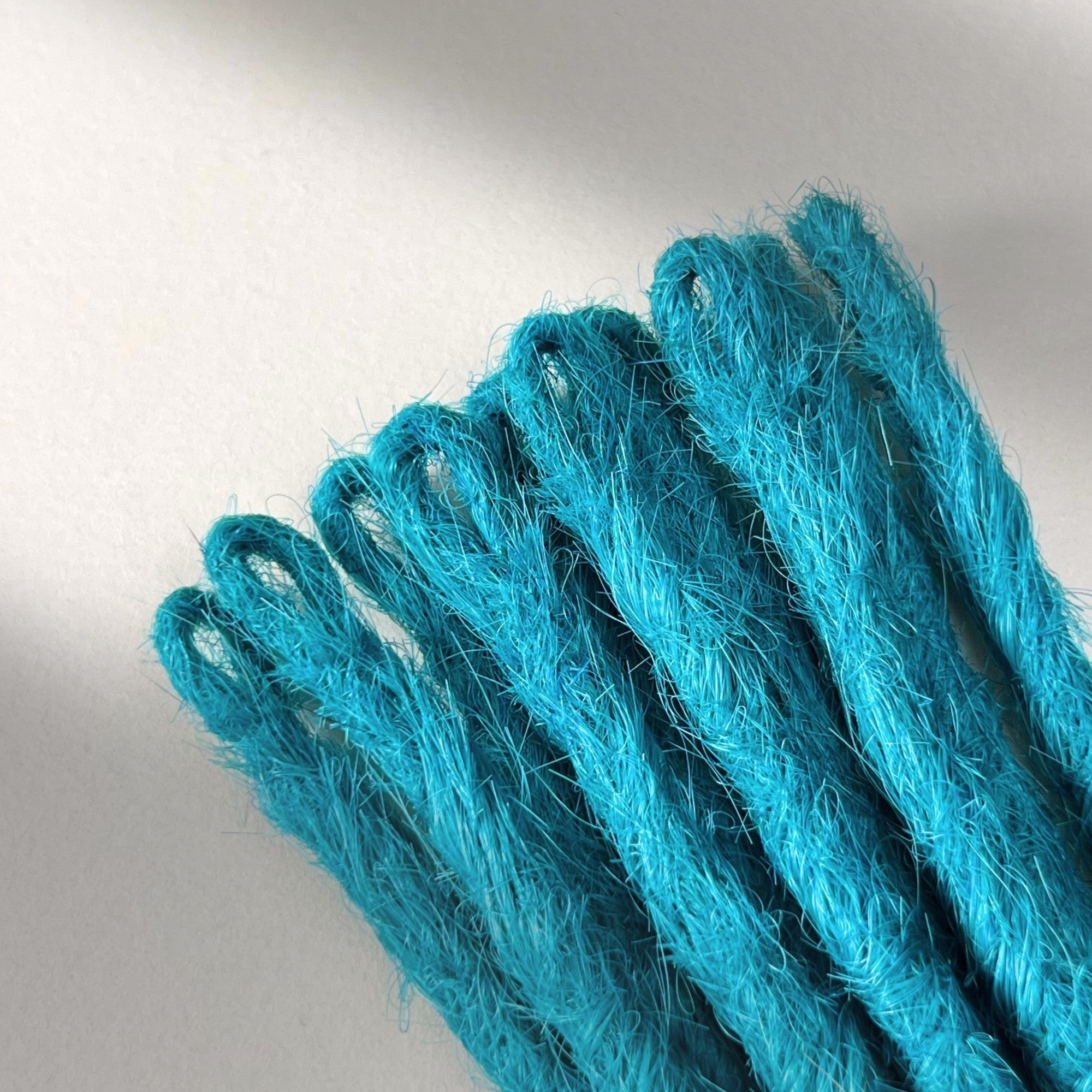 Loop detail of temporary single-ended straight loc extensions in Frost Blue.