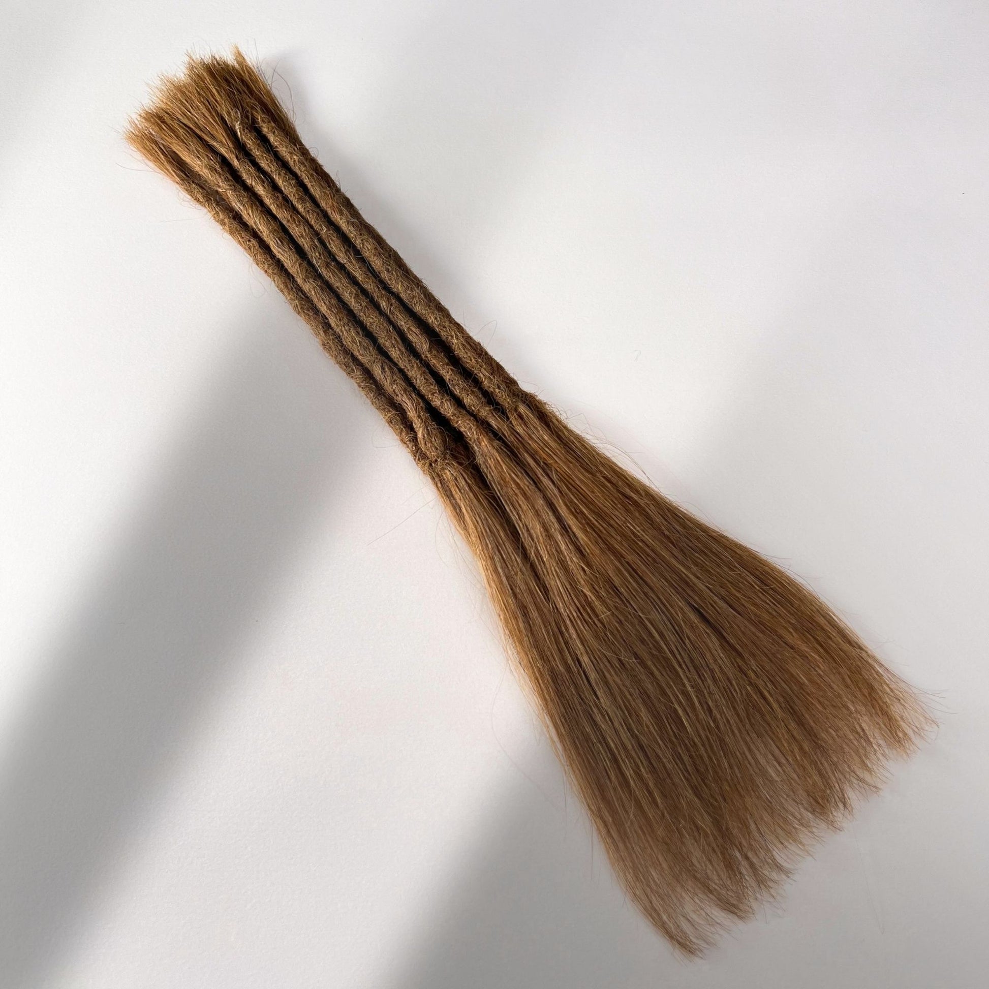 Full view of permanent straight loc extensions with long loose ends in Warm Chestnut Brown.