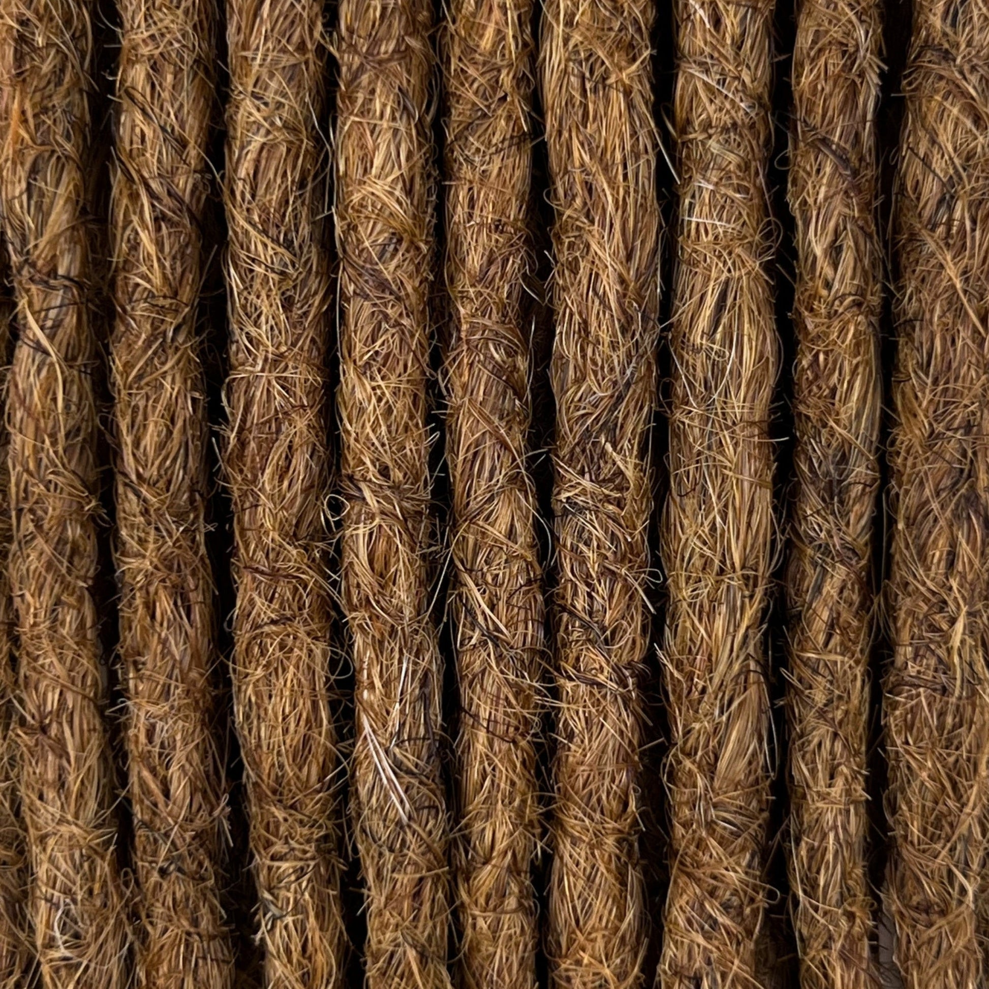 Close-up of straight loc extensions in Warm Chestnut Brown, showing the texture and color.