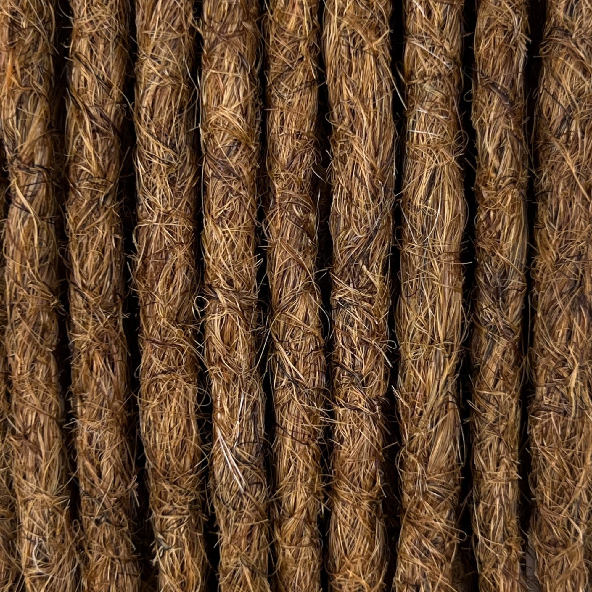Close-up of straight loc extensions in Warm Chestnut Brown, showing the texture and color.