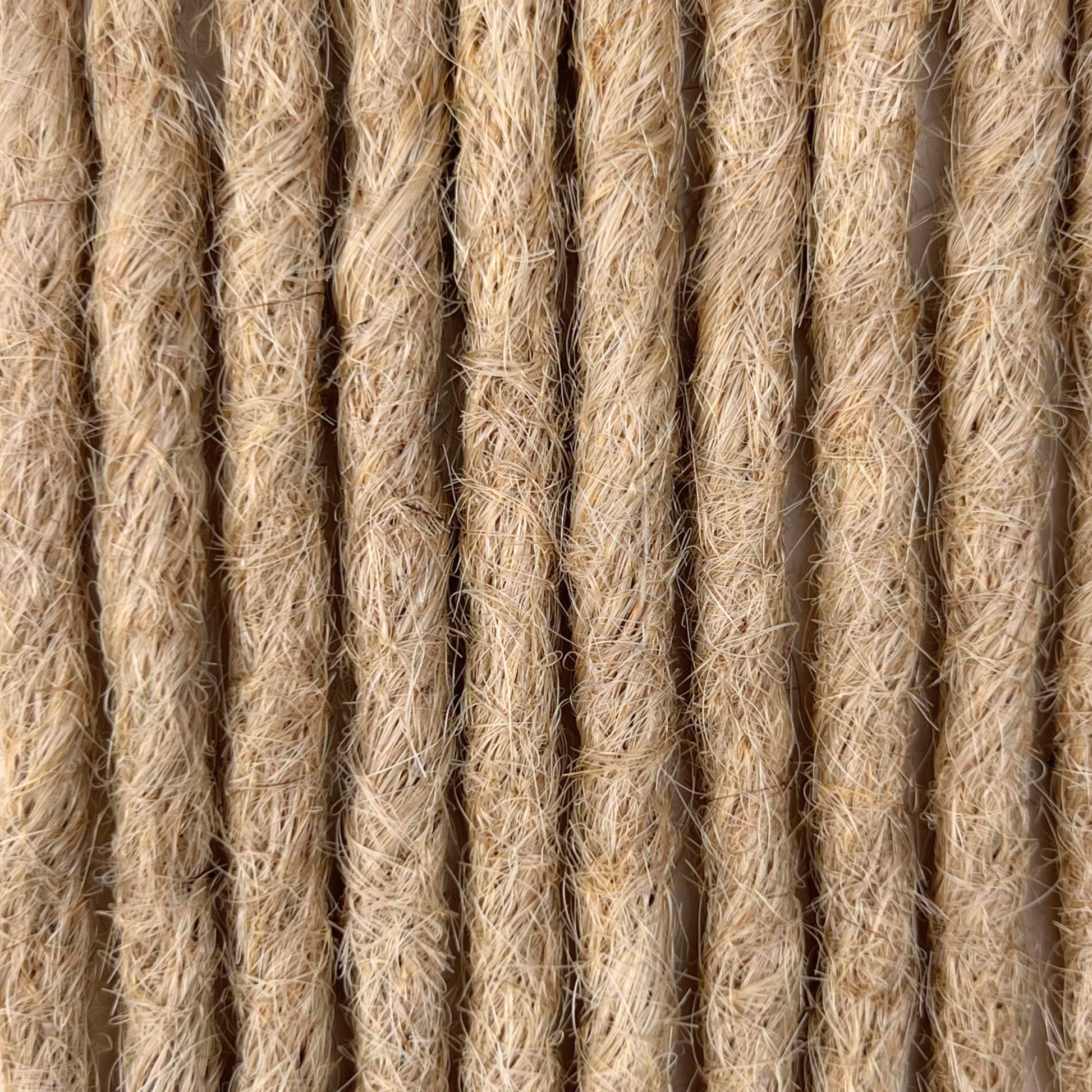 Close-up of straight loc extensions in Sunlit Blonde, showing the texture and color.