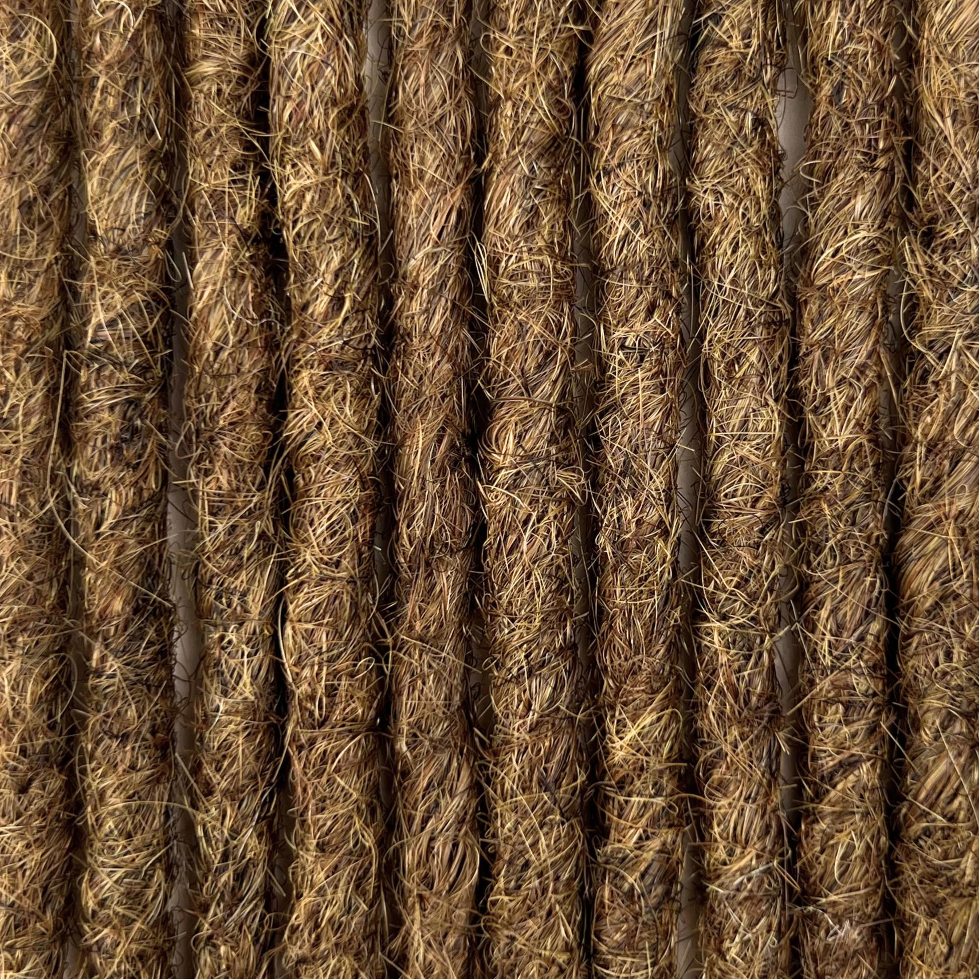 Close-up of straight loc extensions in Natural Medium Brown, showing the texture and color.