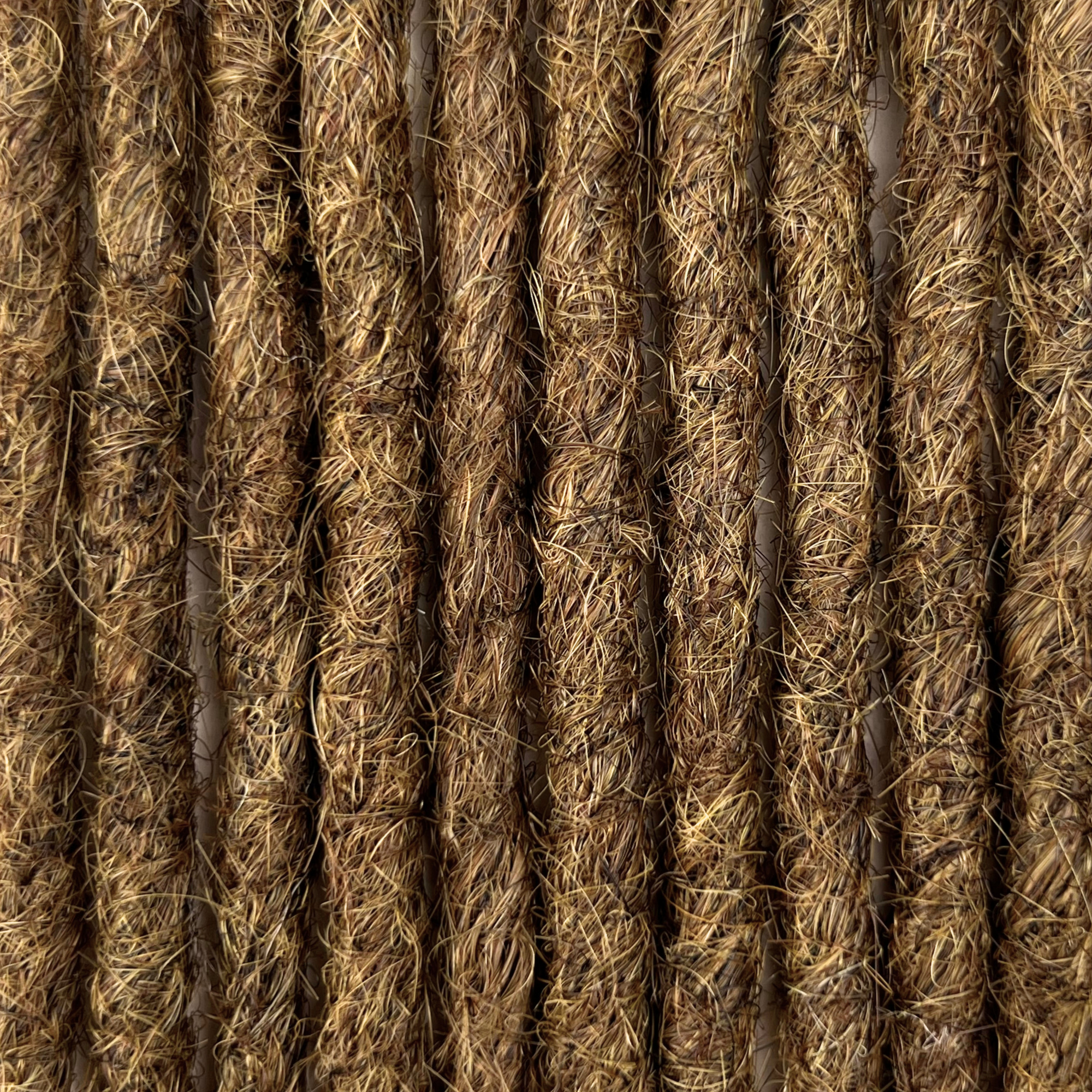 Close-up of straight loc extensions in Natural Medium Brown, showing the texture and color.