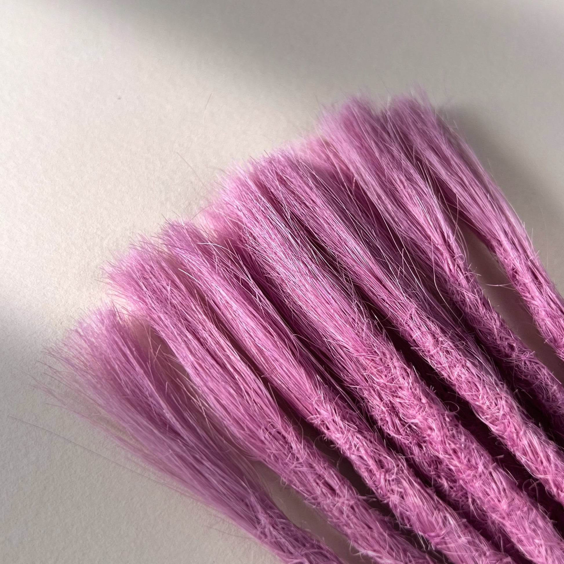 Connection point of permanent straight loc extensions in Lavender Purple.