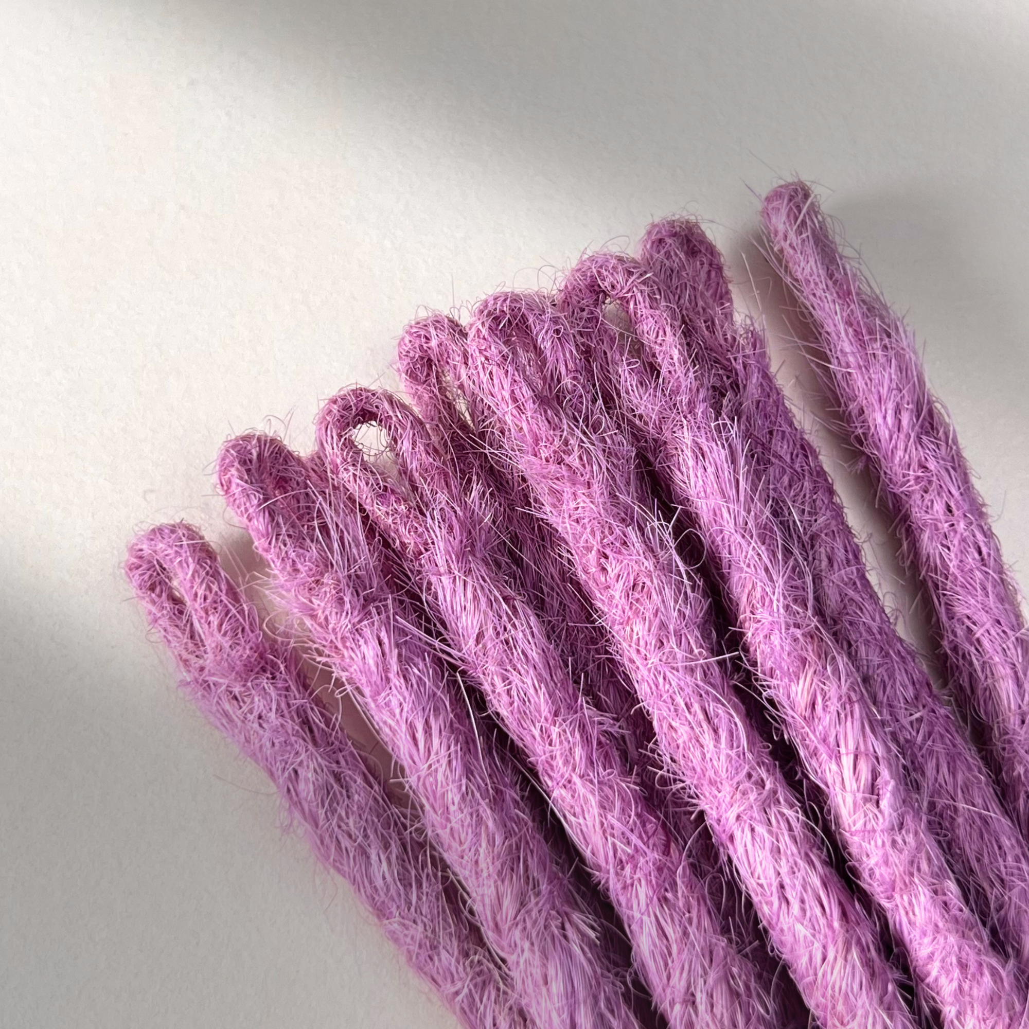 Loop detail of temporary single-ended straight loc extensions in Lavender Purple.