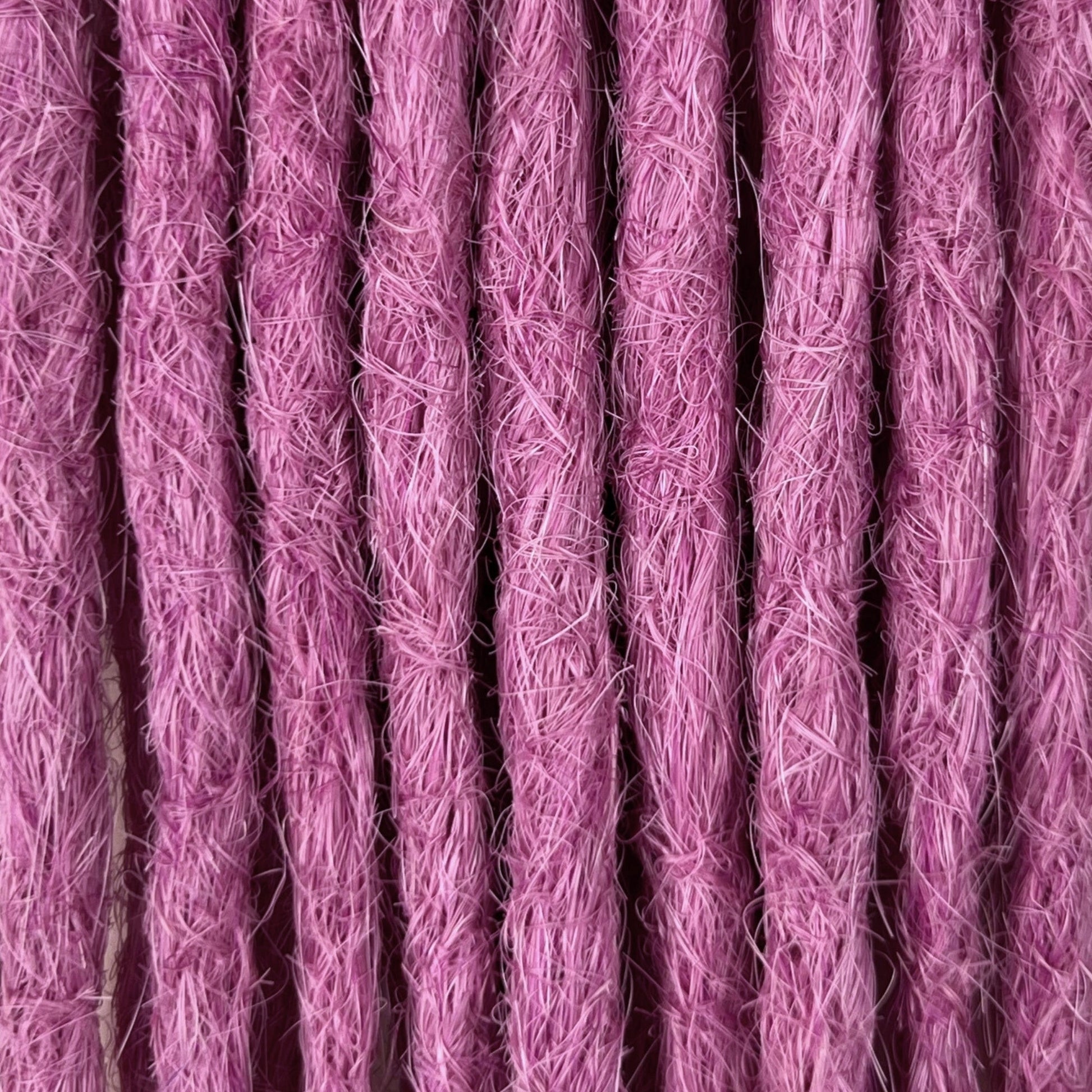Close-up of straight loc extensions in Lavender Purple, showing the texture and color.