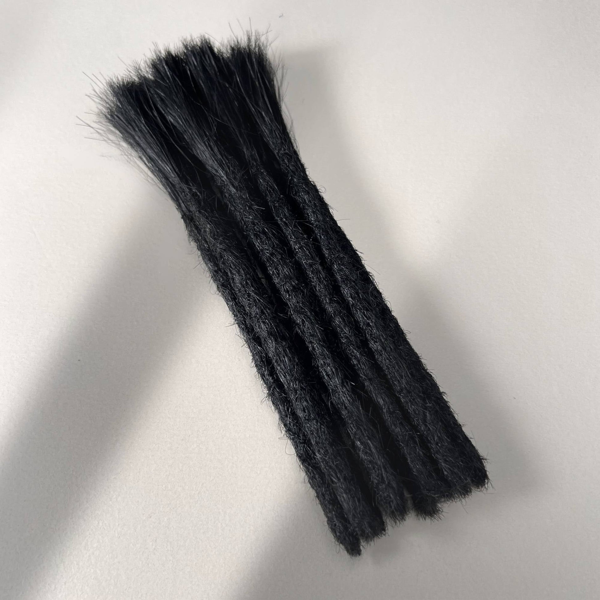 Full view of permanent straight loc extensions with blunt ends in Deepest Black.
