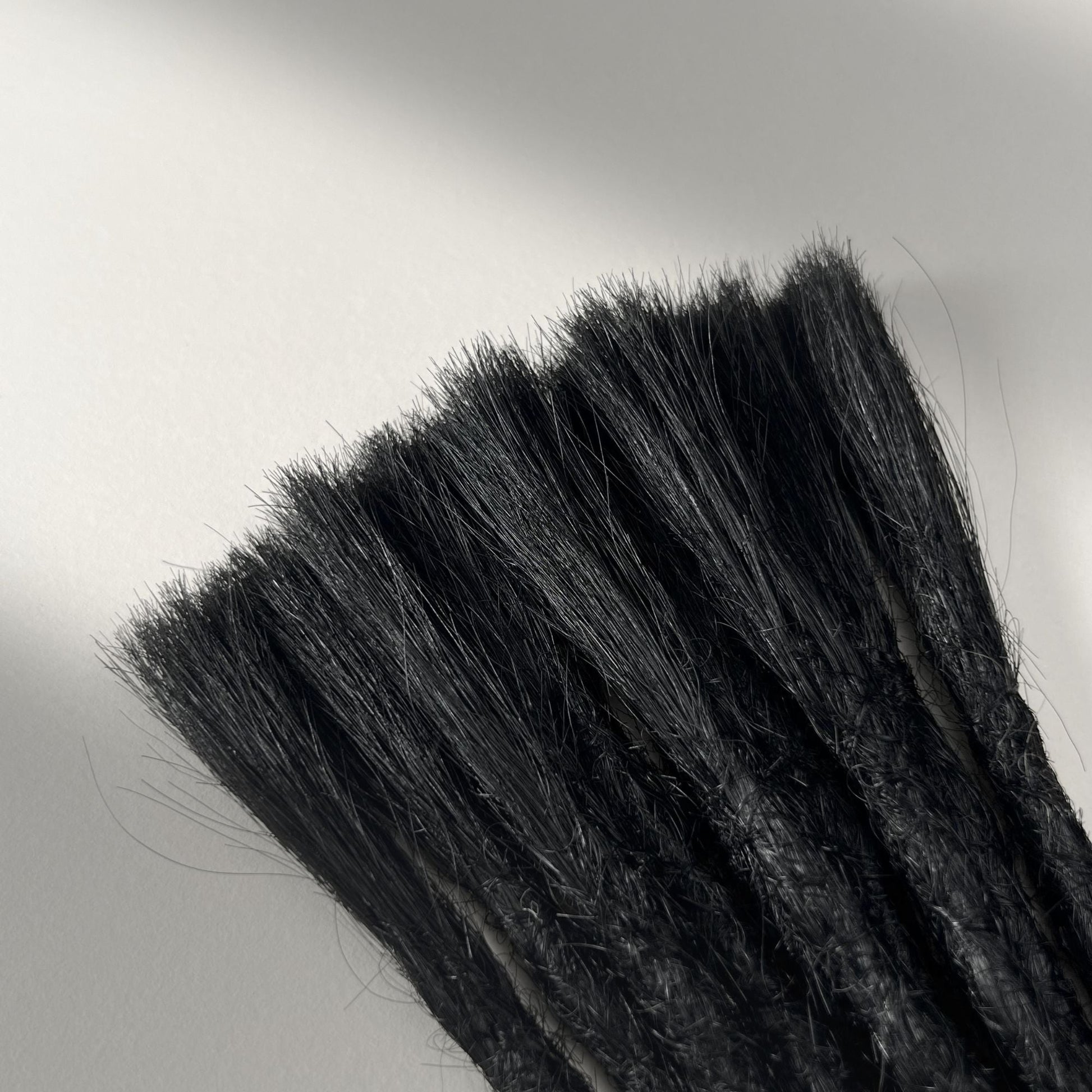 Connection point of permanent straight loc extensions with open ends in Deepest Black.