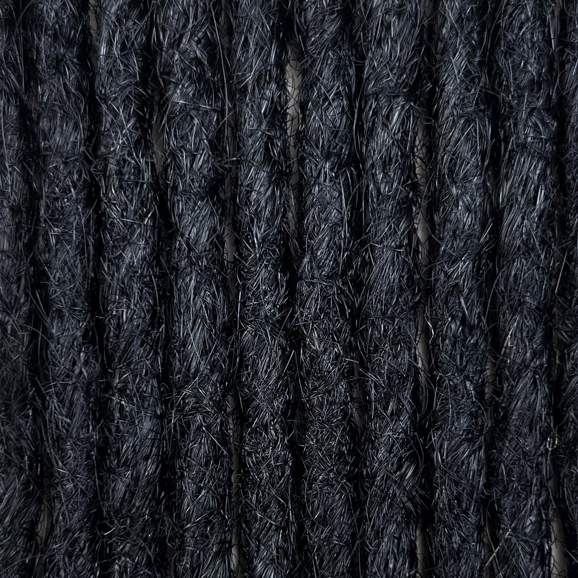 Texture detail of straight loc extensions in Deepest Black.