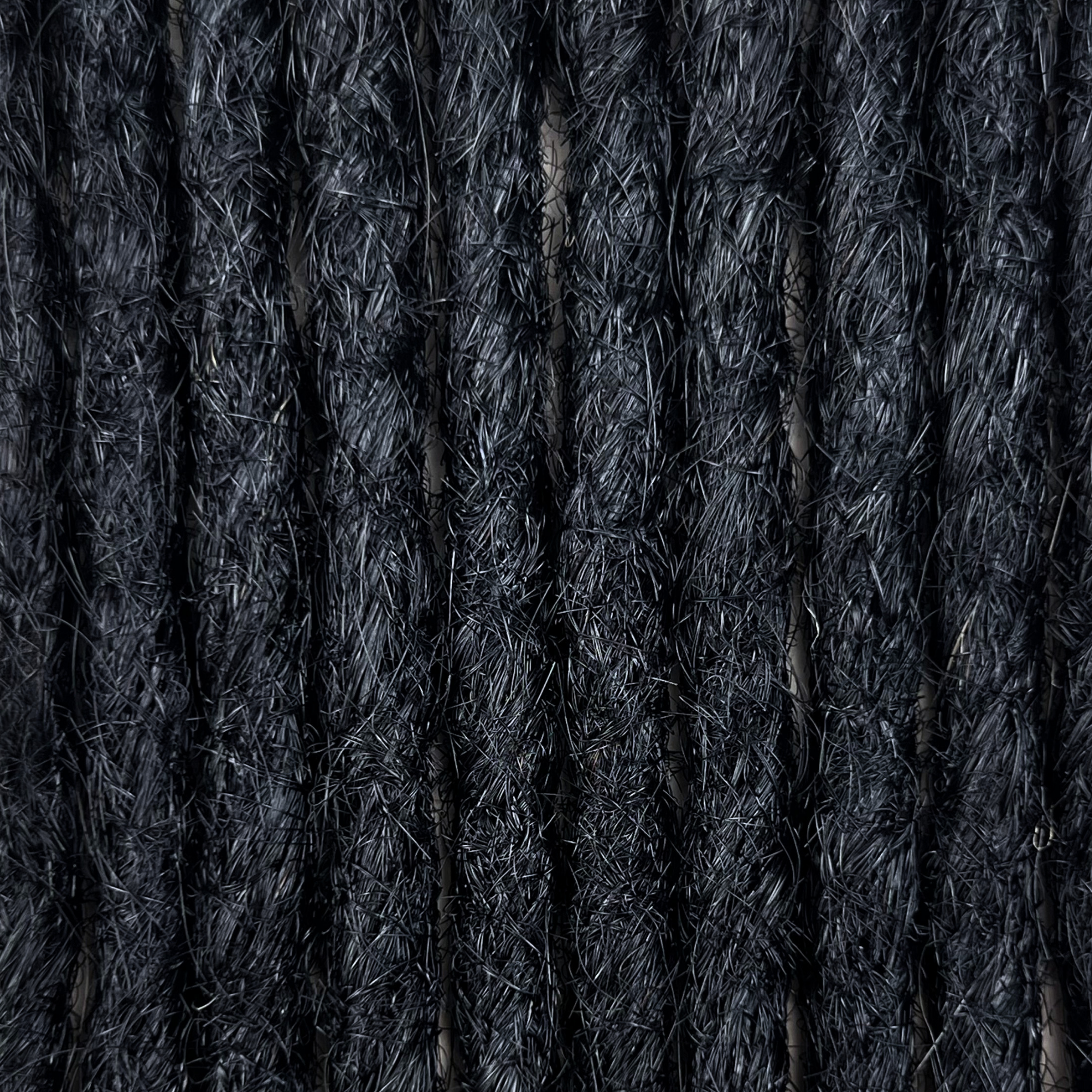 Texture detail of straight loc extensions in Deepest Black.
