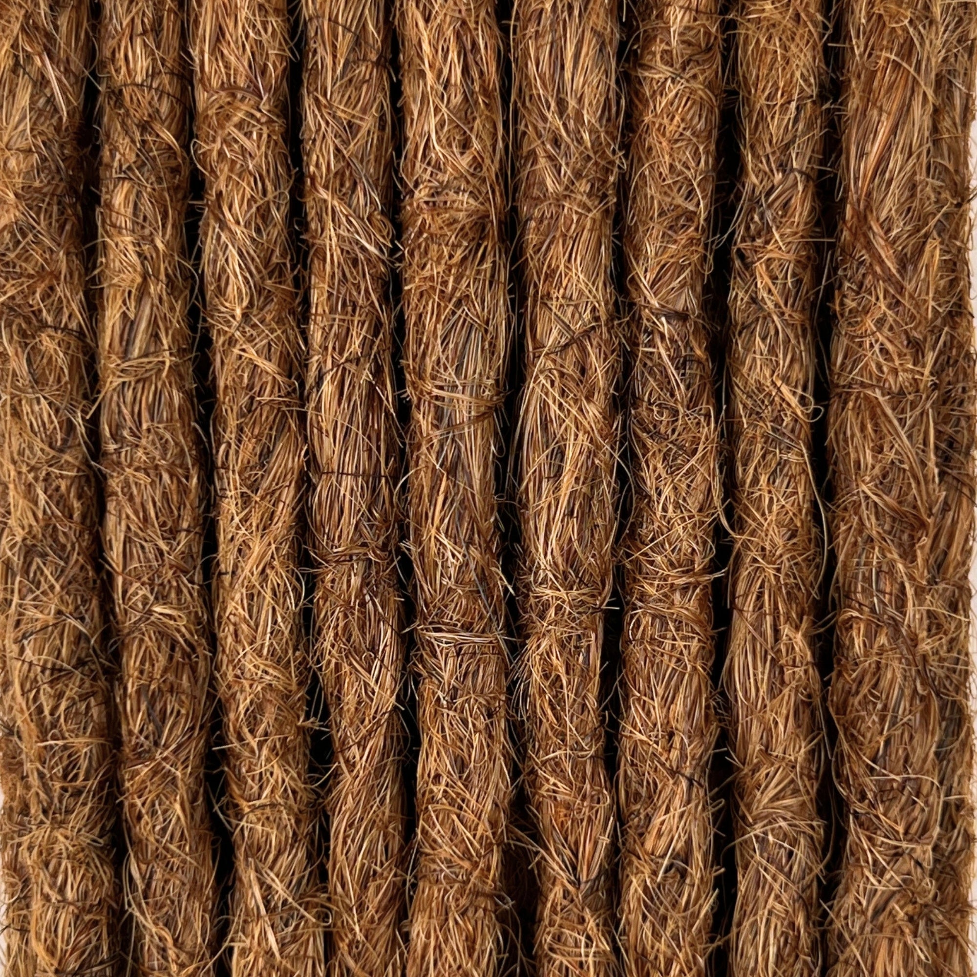Close-up of straight loc extensions in Auburn Copper, showing the texture and color.