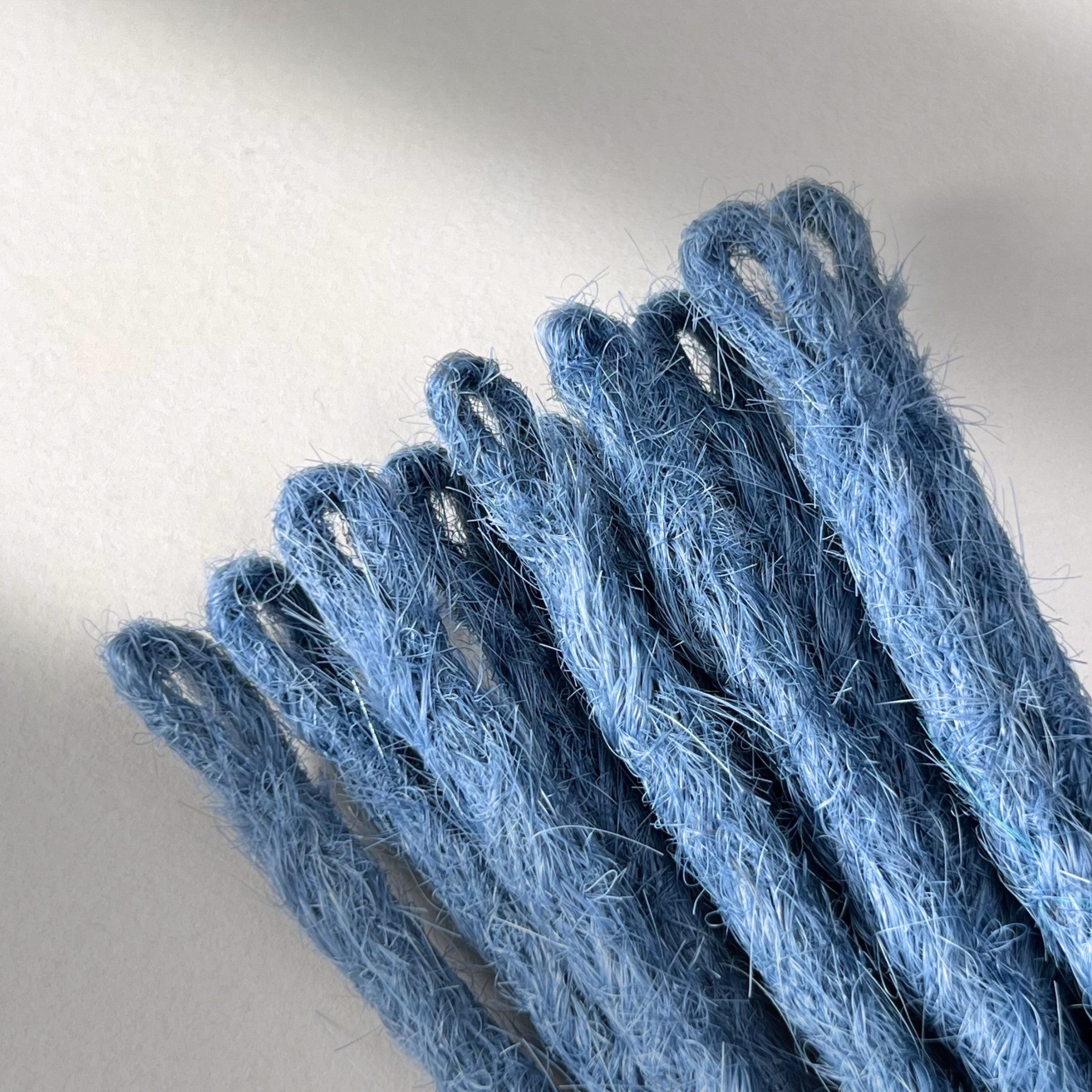 Loop detail of temporary single-ended straight loc extensions in Sky Blue.
