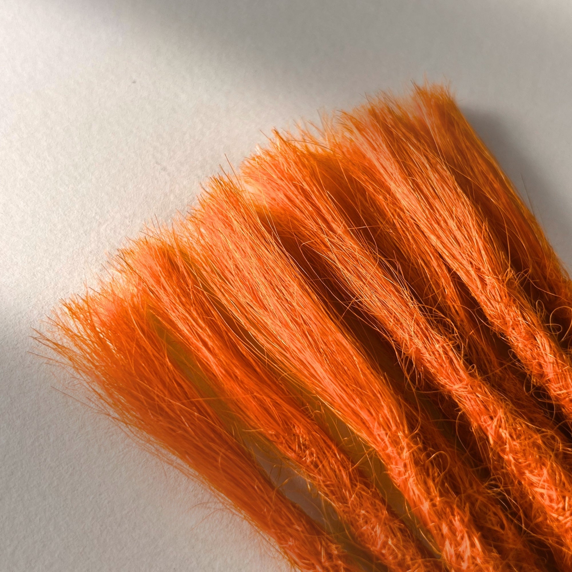 Connection point of permanent straight loc extensions in Burnt Orange.