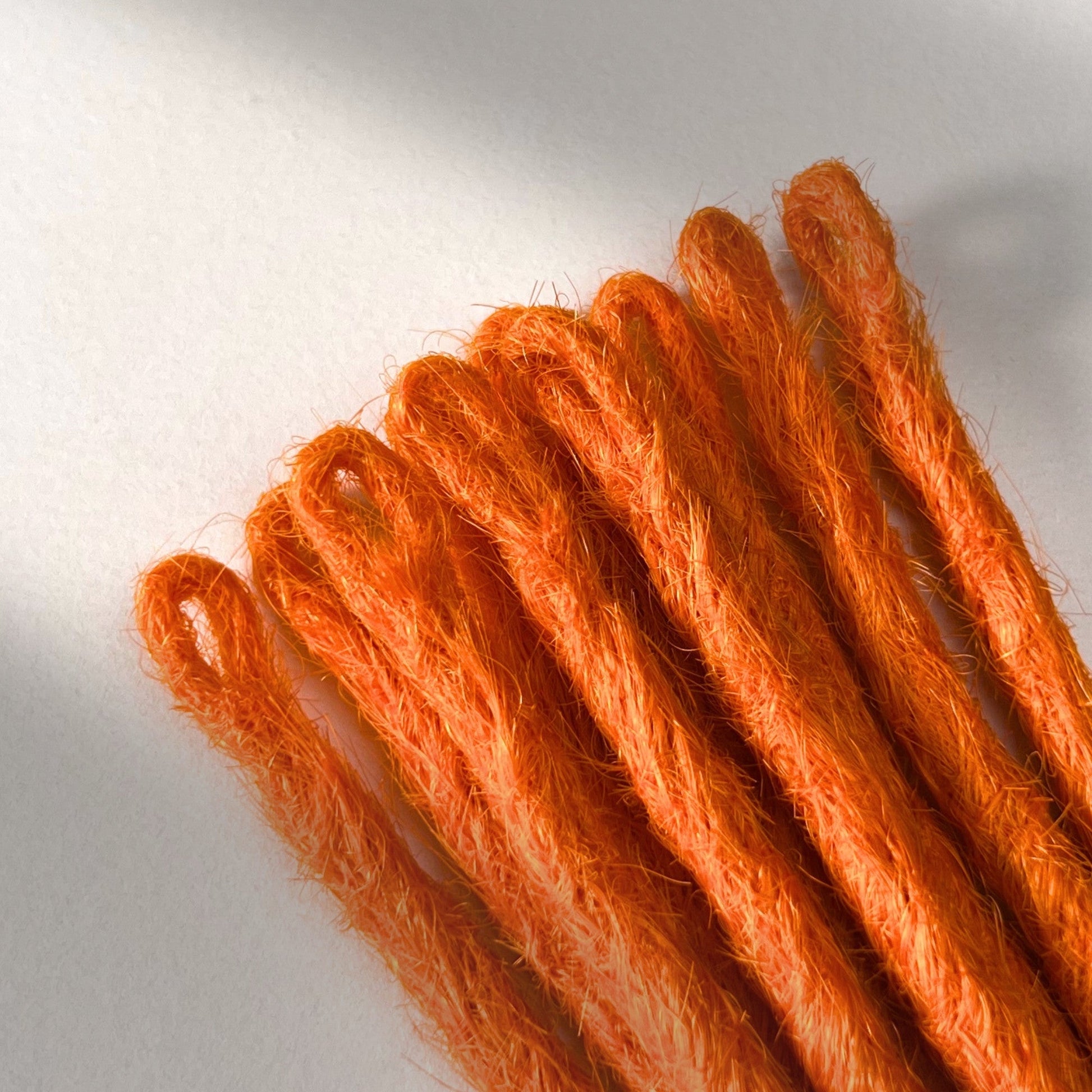 Loop detail of temporary single-ended straight loc extensions in Burnt Orange.