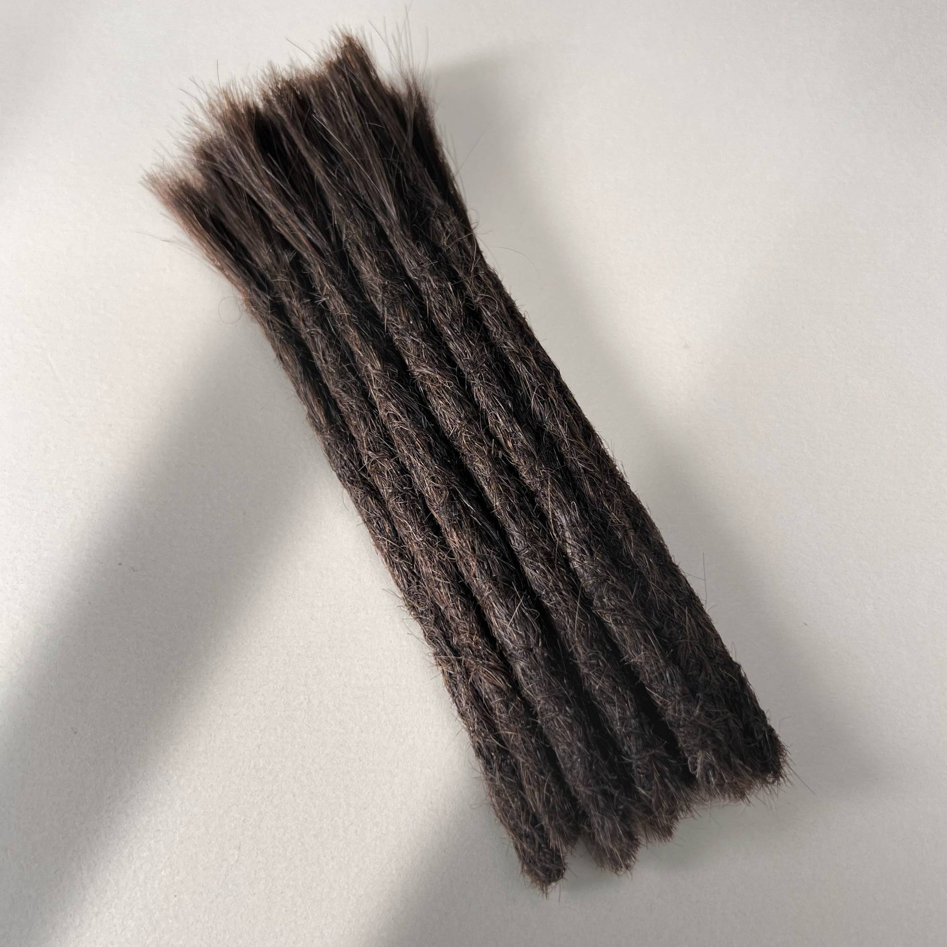 Full view of permanent straight loc extensions with blunt ends in Warm Espresso Brown.