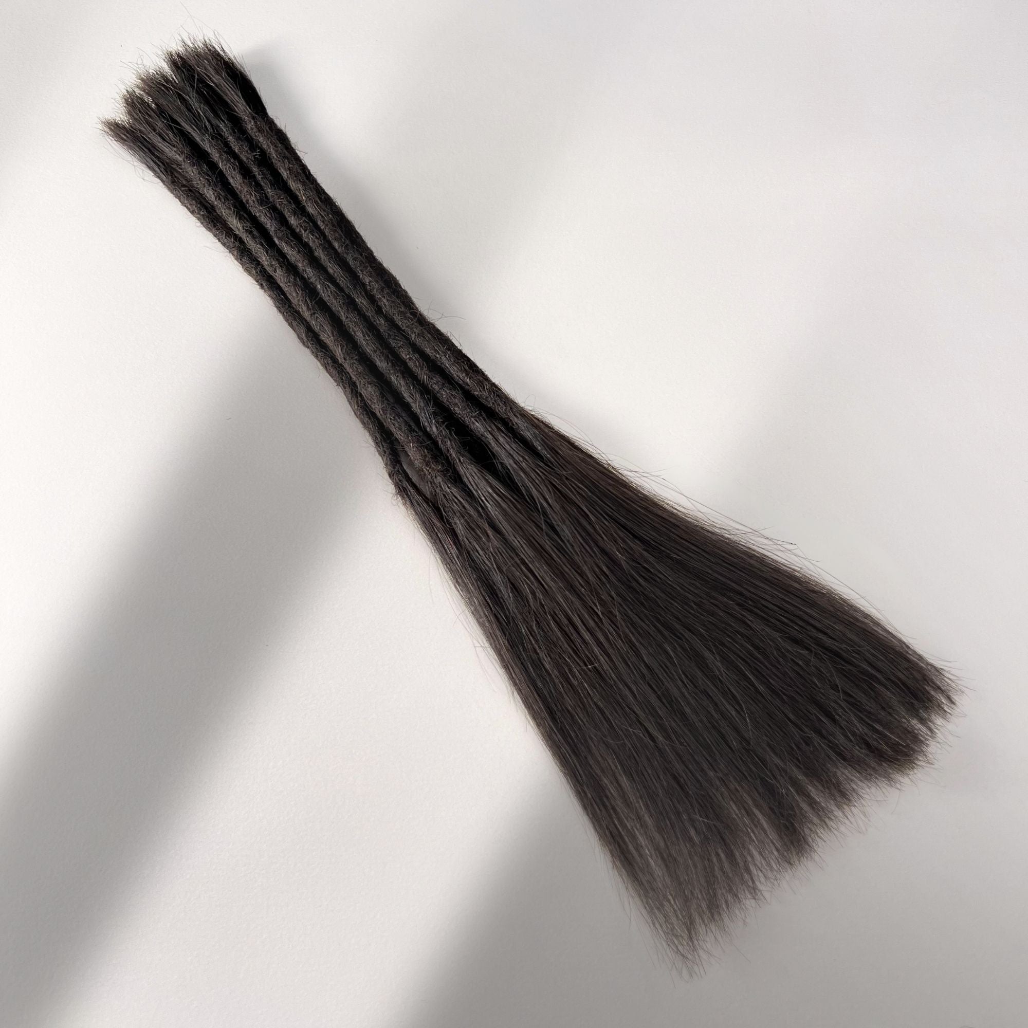 Full view of permanent straight loc extensions with long loose ends in Warm Espresso Brown.