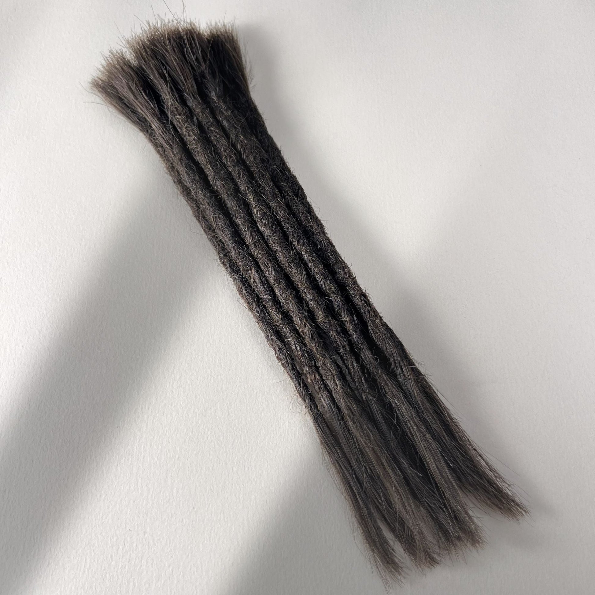 Full view of permanent straight loc extensions with open ends in Warm Espresso Brown.