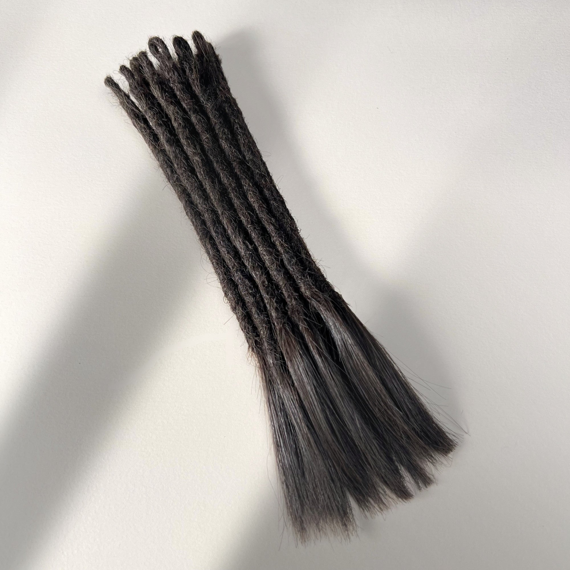 Full view of temporary single-ended straight loc extensions with open ends in Warm Espresso Brown.